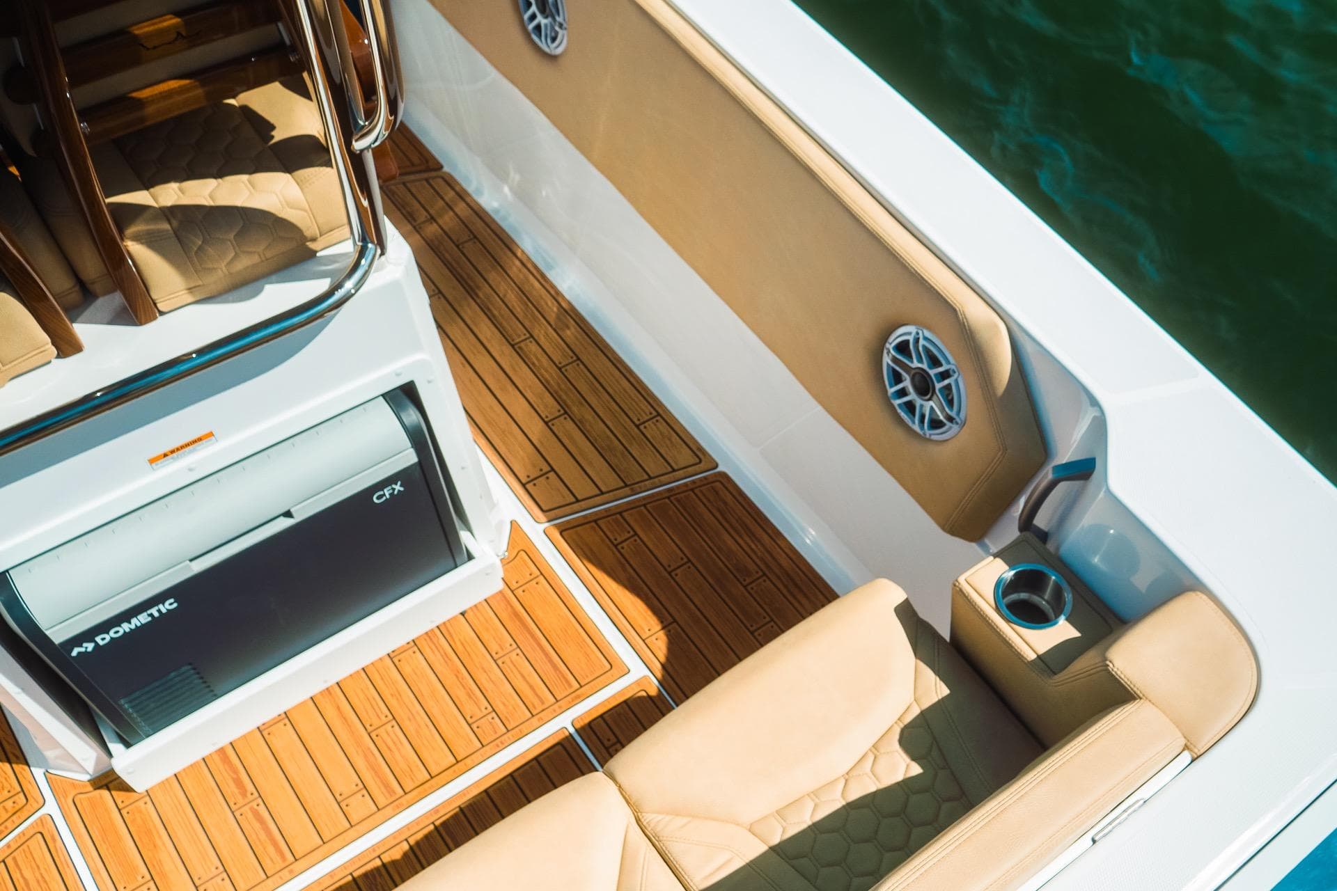Luxurious 2023 Dynamic D-305V boat interior with teak flooring and cushioned seating.