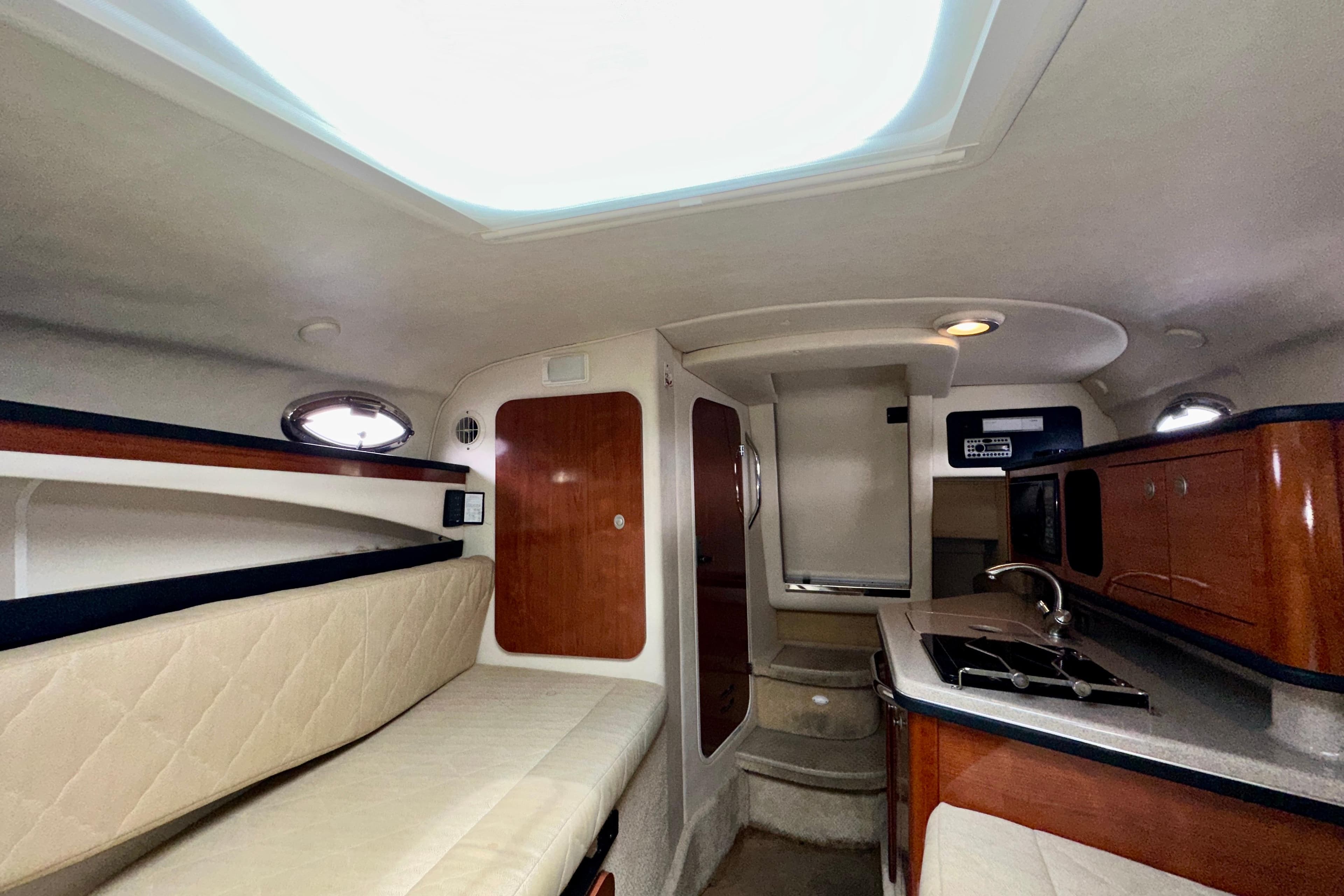 Interior of 2006 Sea Ray 260 Sundancer boat with kitchenette and seating area.
