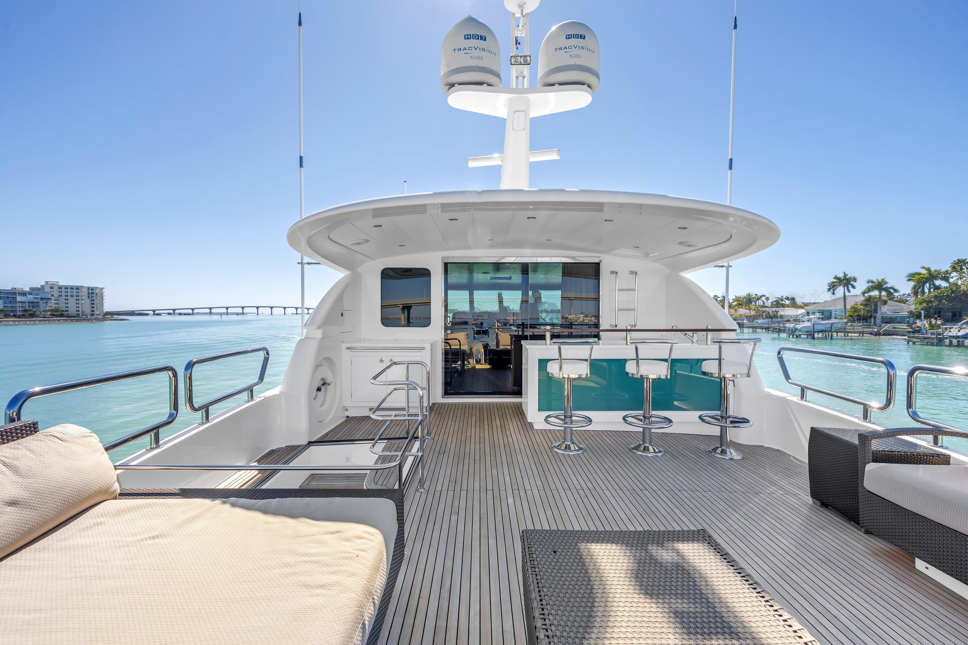 Luxurious 2015 Horizon E88 yacht deck with bar stools and ocean view.