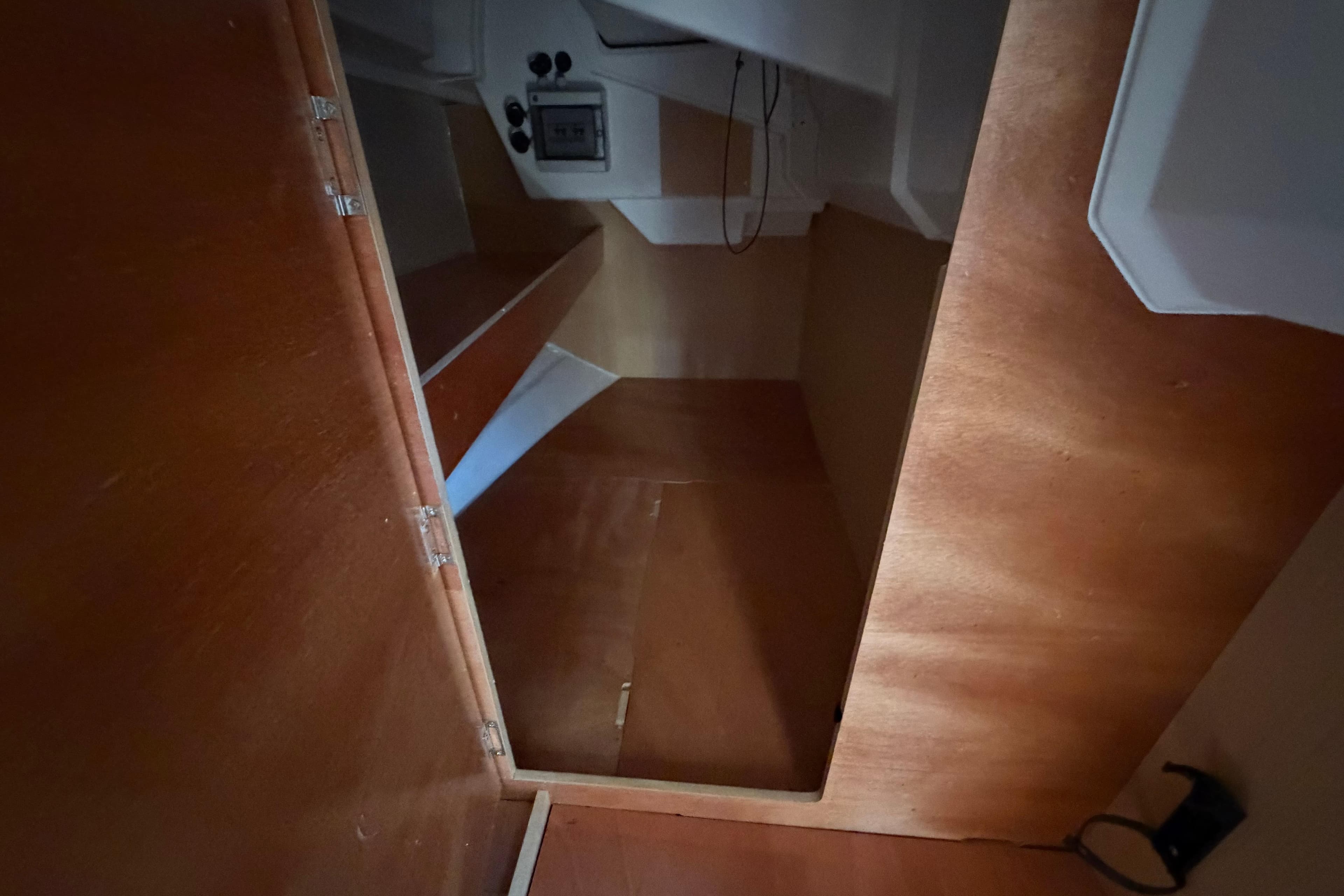 Interior cabin of 2017 Beneteau Oceanis 38 sailboat, featuring wooden finishes and compact design.