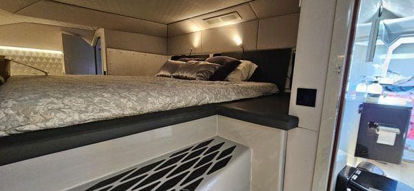 Luxurious cabin interior of 2019 Sunreef 40 Open yacht with elegant bedding and modern lighting.