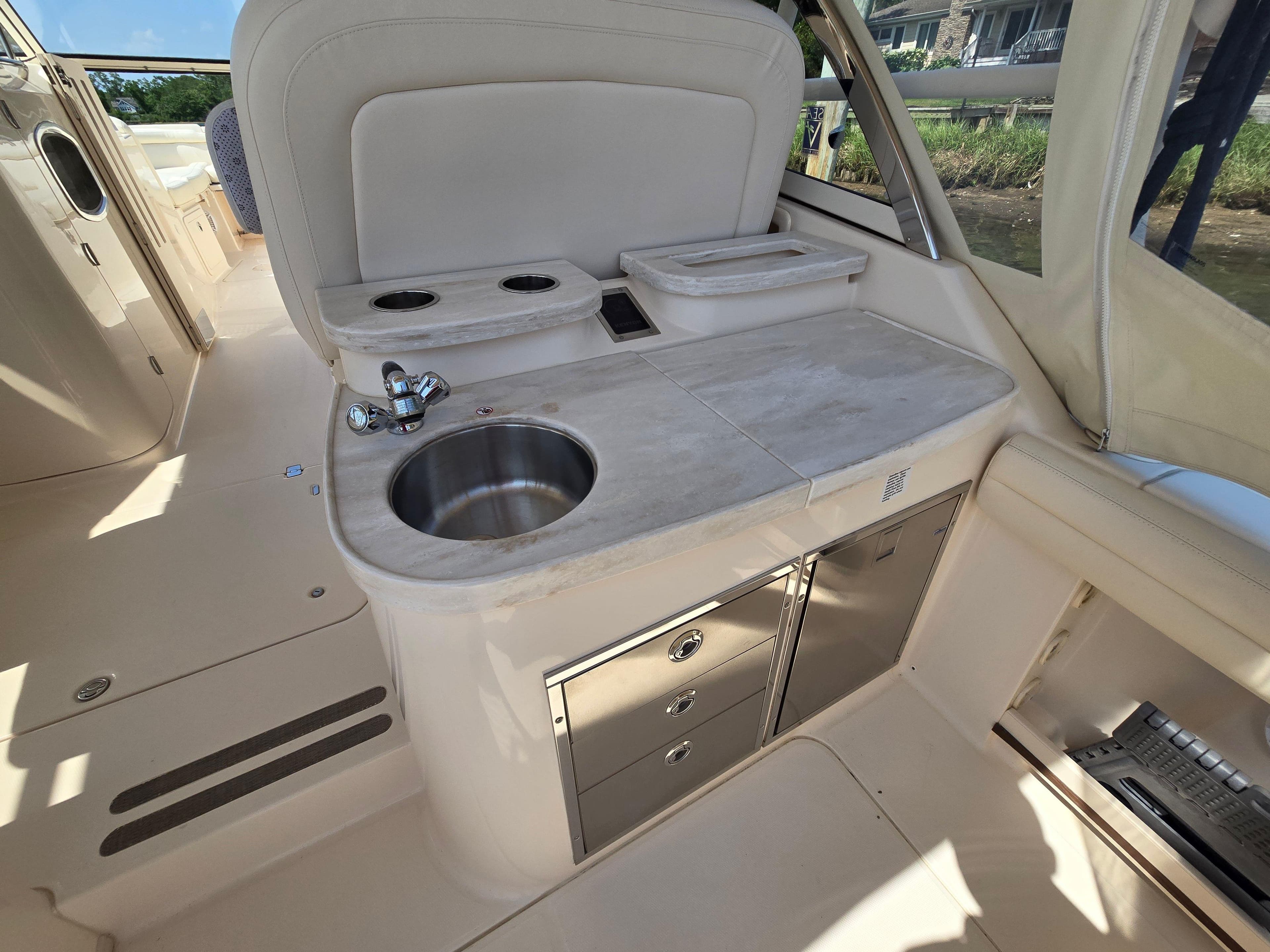 2017 Grady-White Freedom 335 boat interior with sink and storage cabinets.