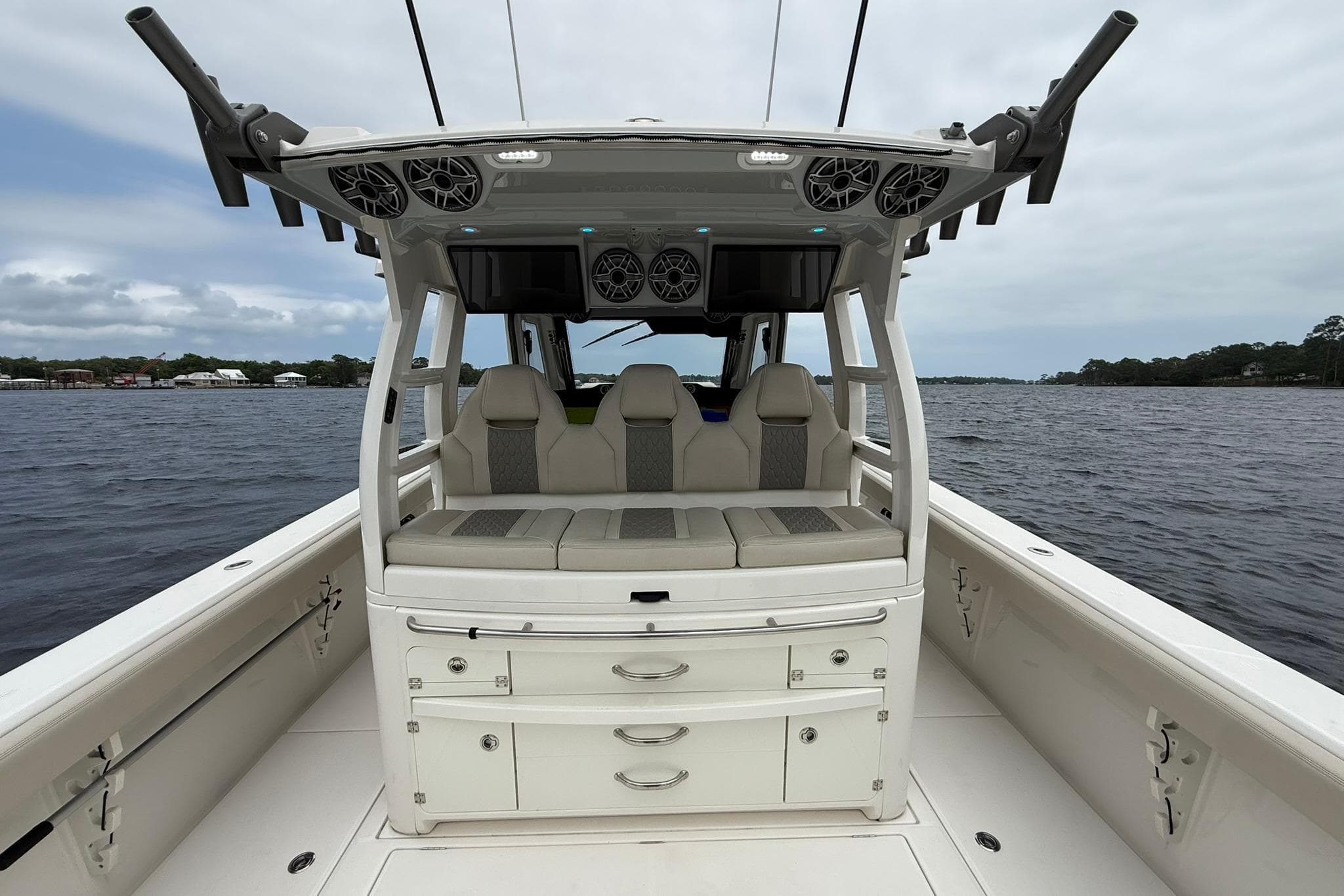 2022 Solace 41CS boat interior with seating and storage, on a calm water backdrop.