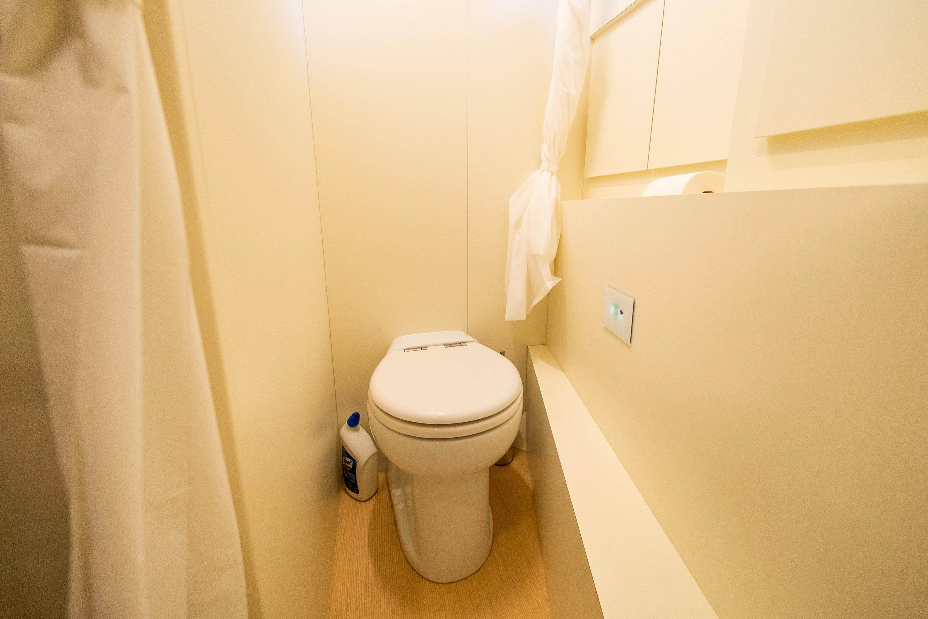 Luxurious bathroom on 2020 Ferretti Yachts 850, featuring modern toilet and sleek design.