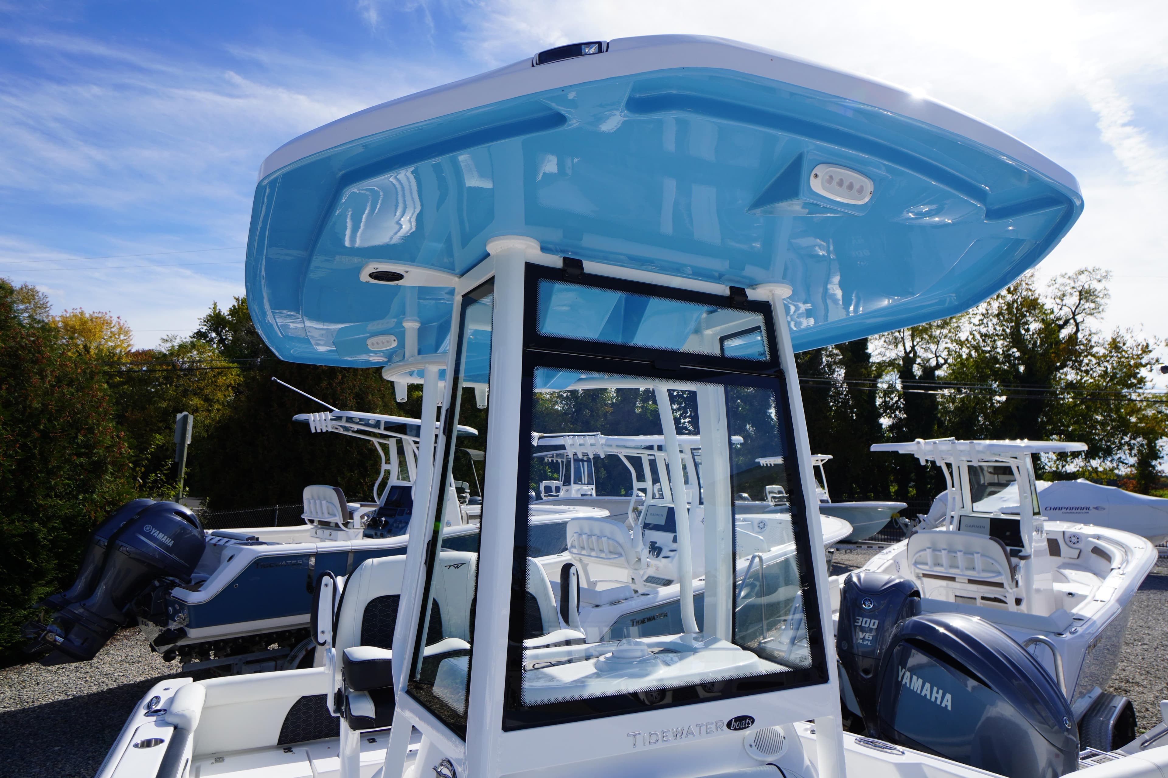 2026 Tidewater 220 LXF boat with blue T-top and Yamaha outboard engines.