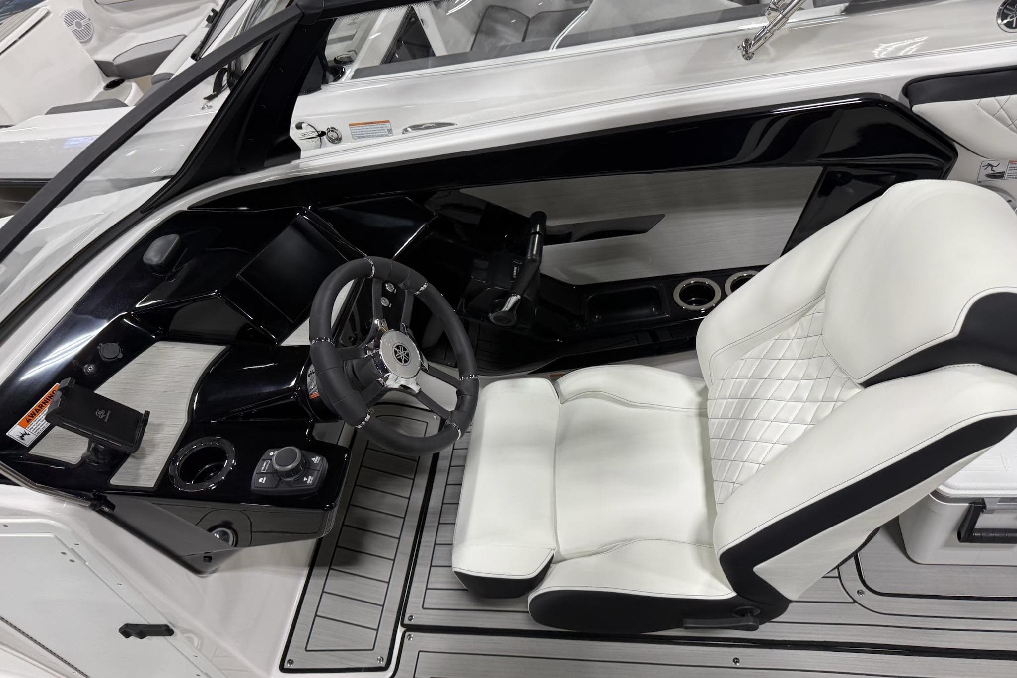 Interior of 2026 Yamaha Boats 222S, featuring sleek steering and luxurious seating.