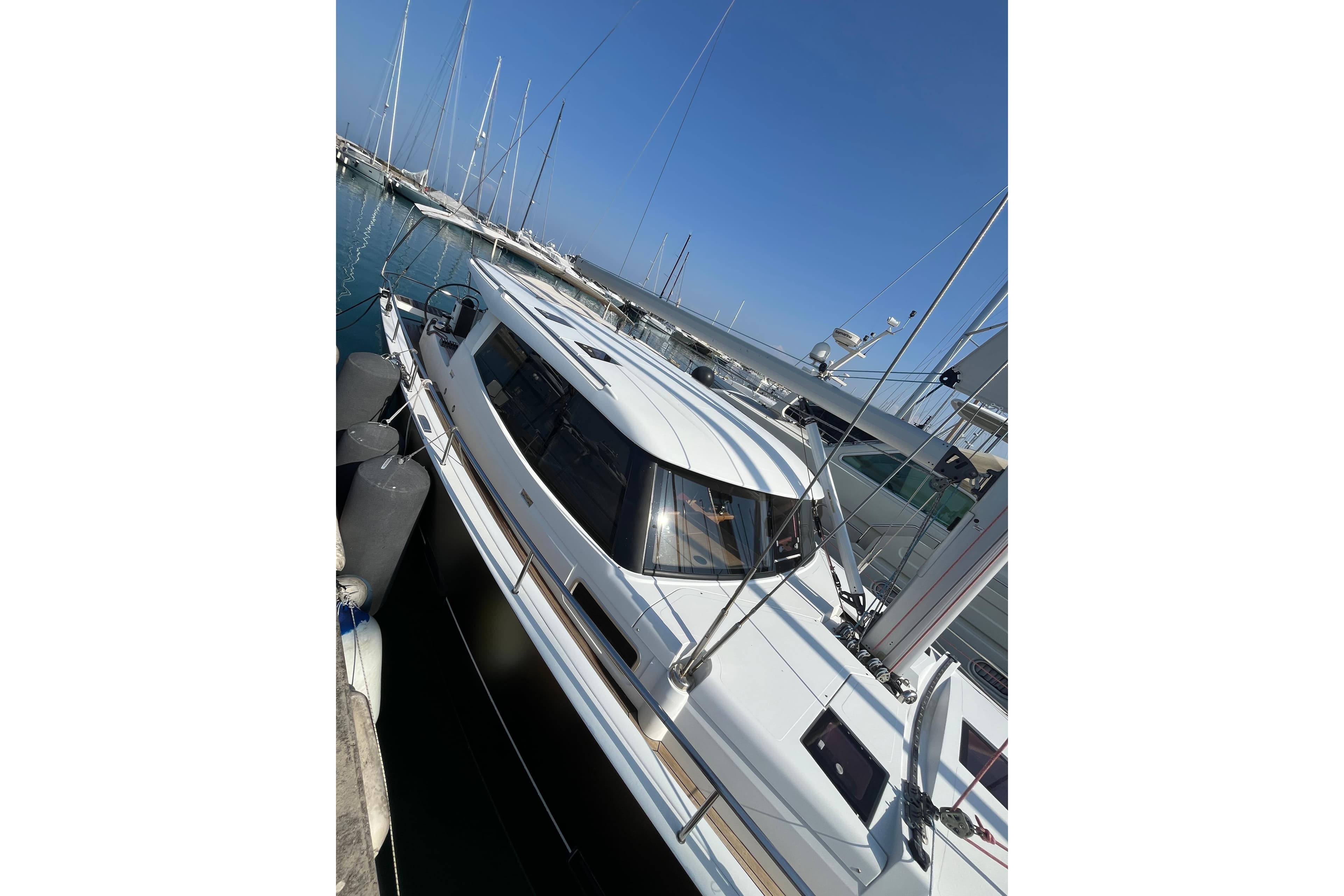 Sailing yacht Moody 45 DS, 2012 model, docked in a marina under clear blue skies.