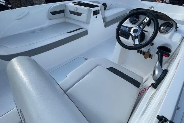 2023 Hurricane SunDeck Sport 185 OB boat interior with steering wheel and seating.