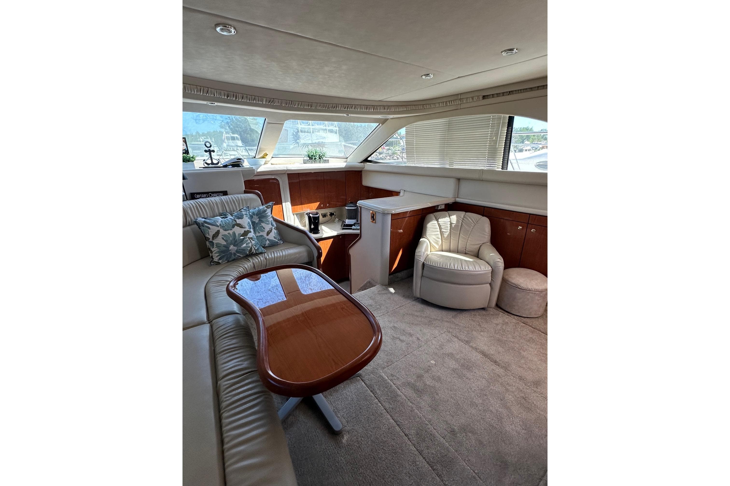 Luxurious interior of 2000 Sea Ray 380 Aft Cabin yacht with plush seating and elegant decor.