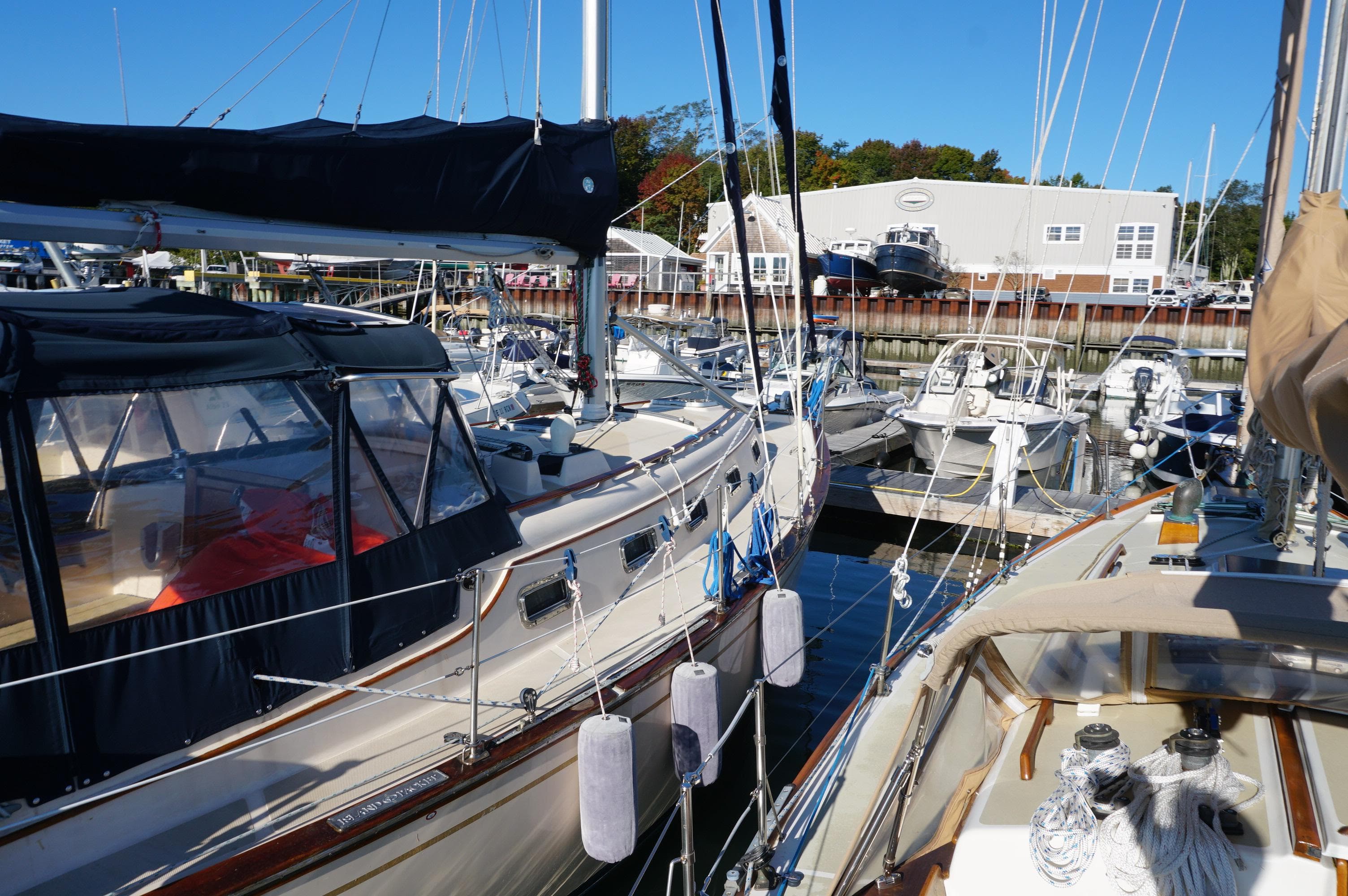 1994 Island Packet 32 sailboat docked in a marina, surrounded by other boats.