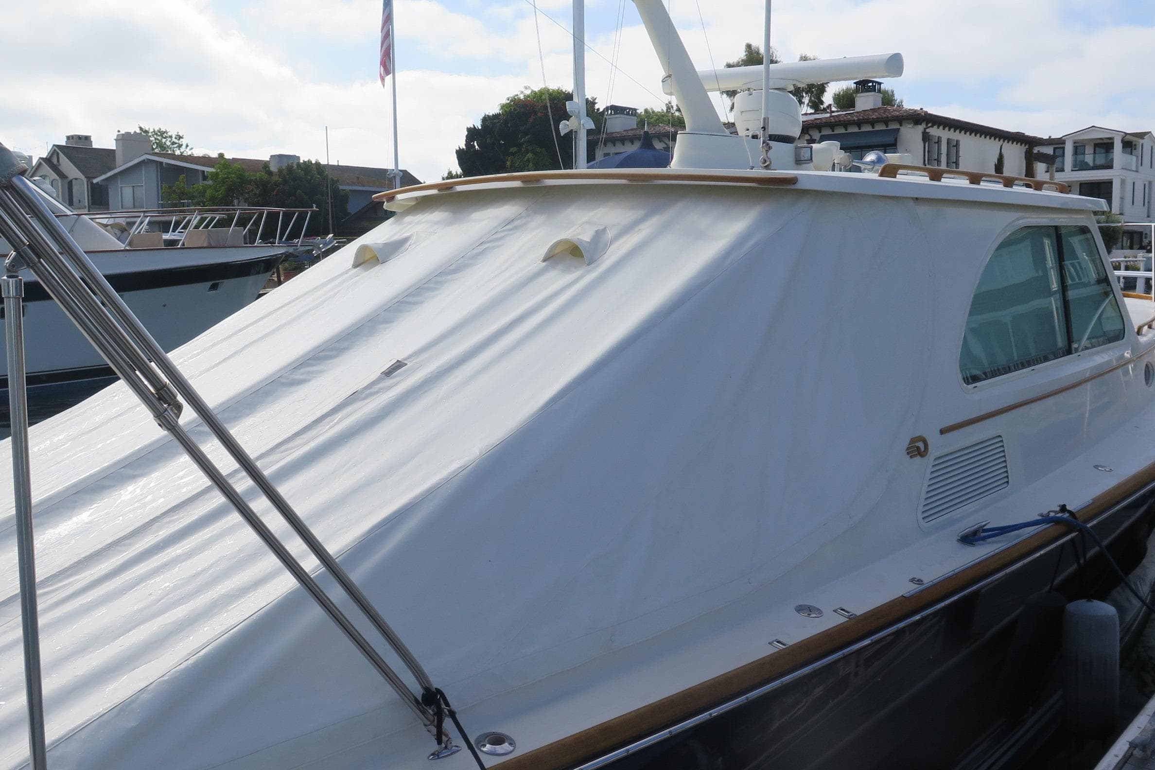 2007 Hinckley Talaria 40 yacht docked, featuring sleek design and covered deck.