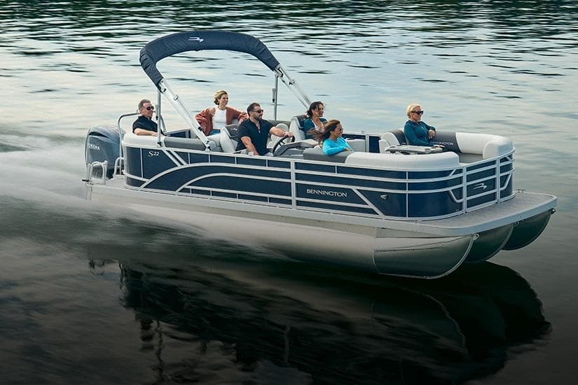 2026 Bennington 22 S-One Swingback pontoon boat cruising on a calm lake.