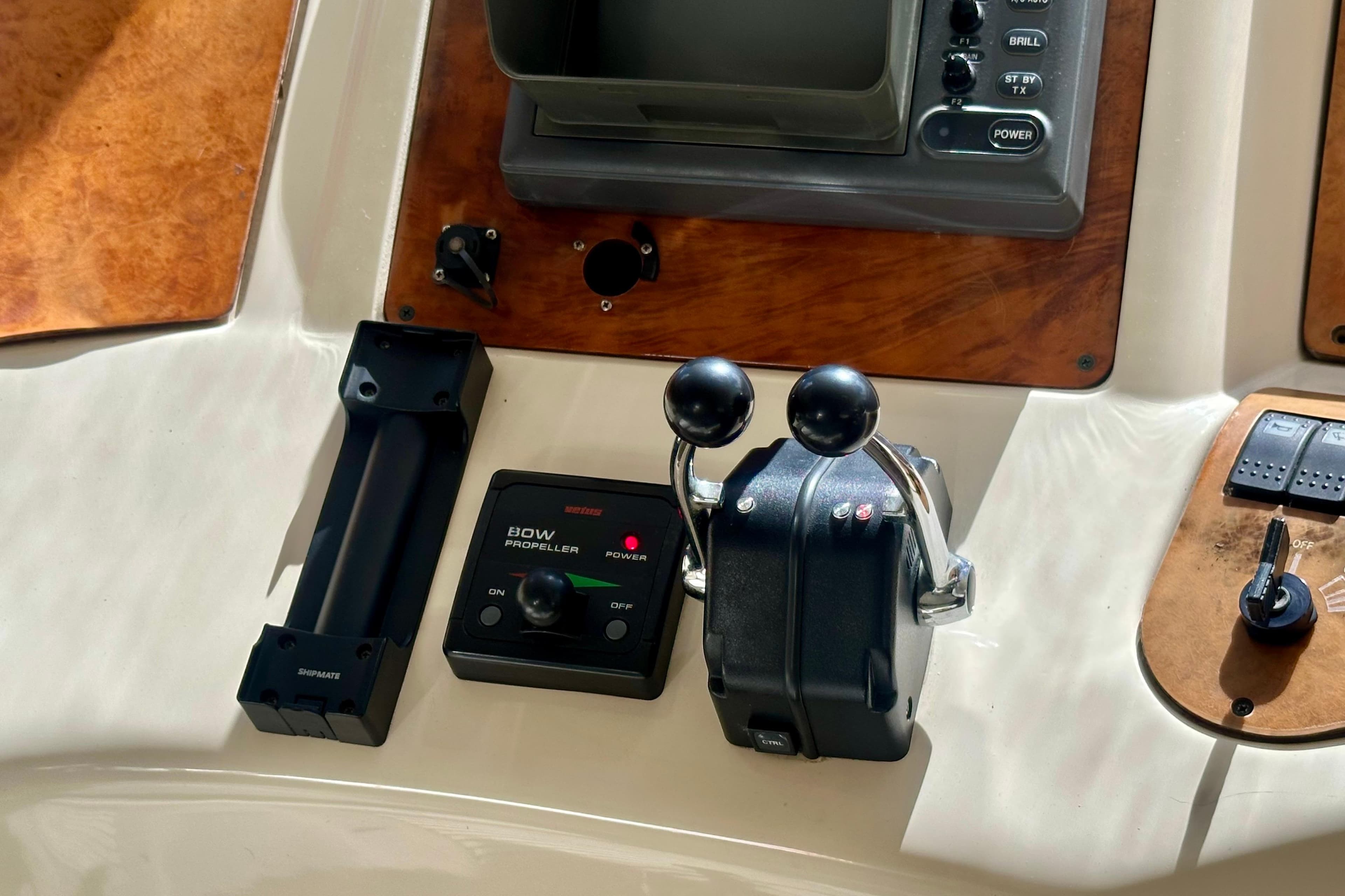 Control panel of a 1999 Azimut 58 yacht with throttle and bow propeller controls.
