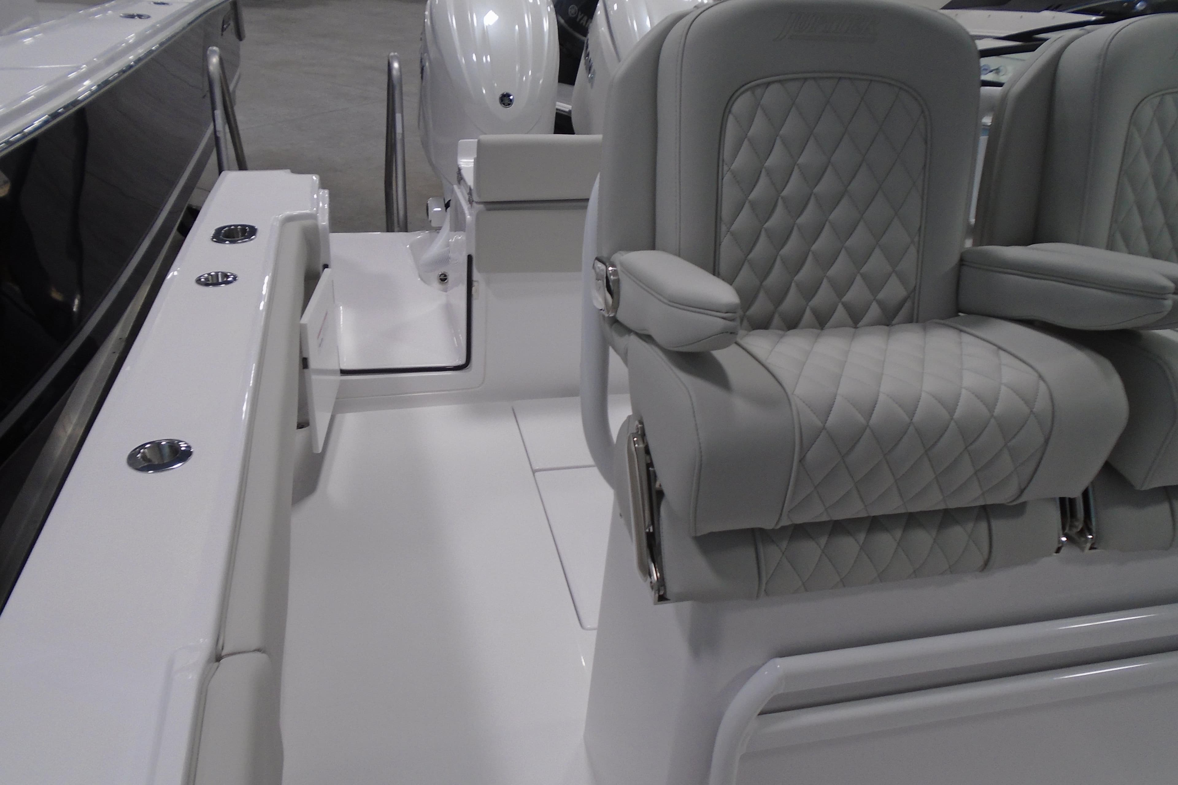 Luxurious seating on a 2026 Jupiter 26 boat, featuring quilted upholstery and sleek design.