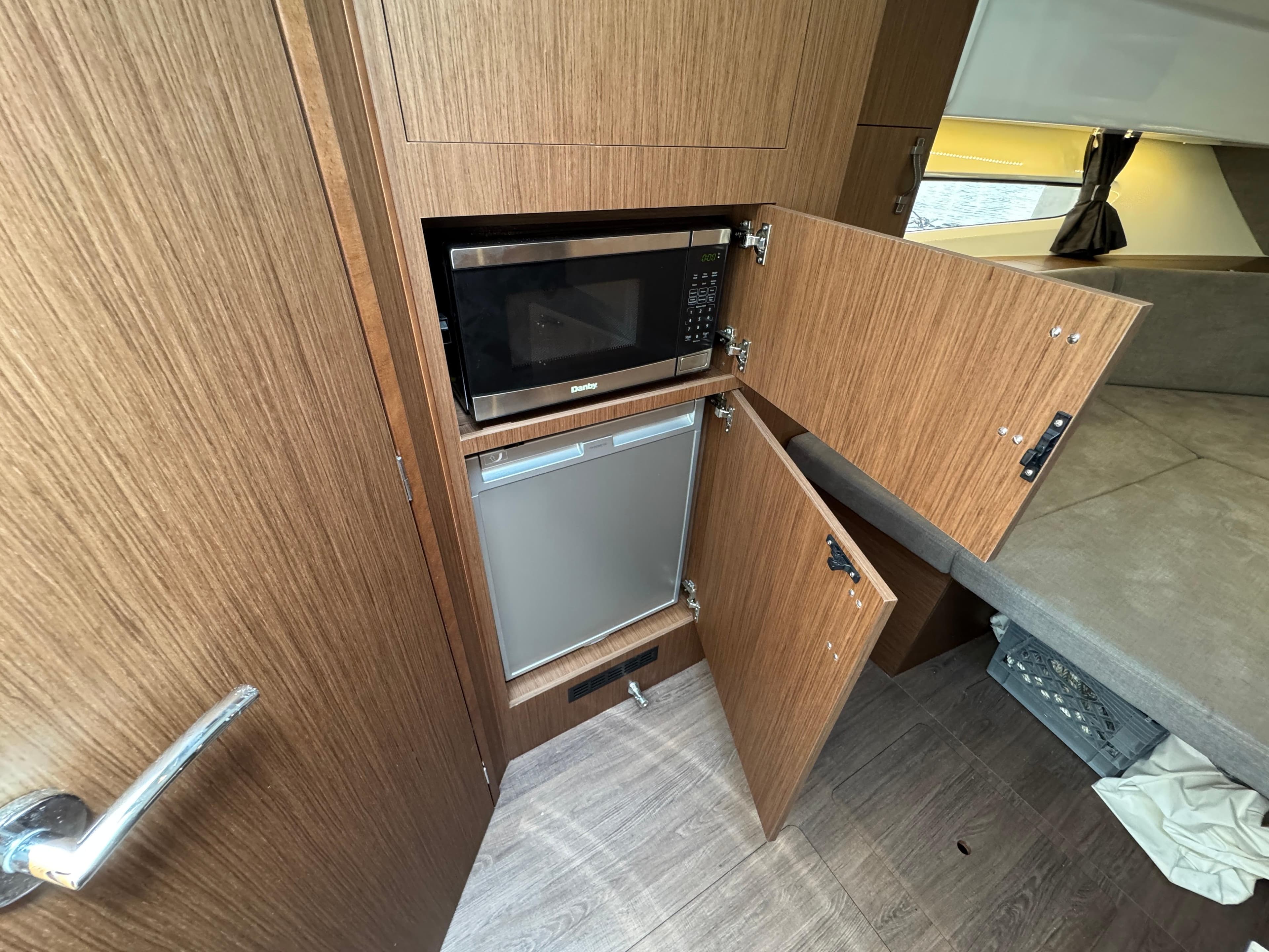 2022 Beneteau Gran Turismo 32 interior kitchen with microwave and fridge.