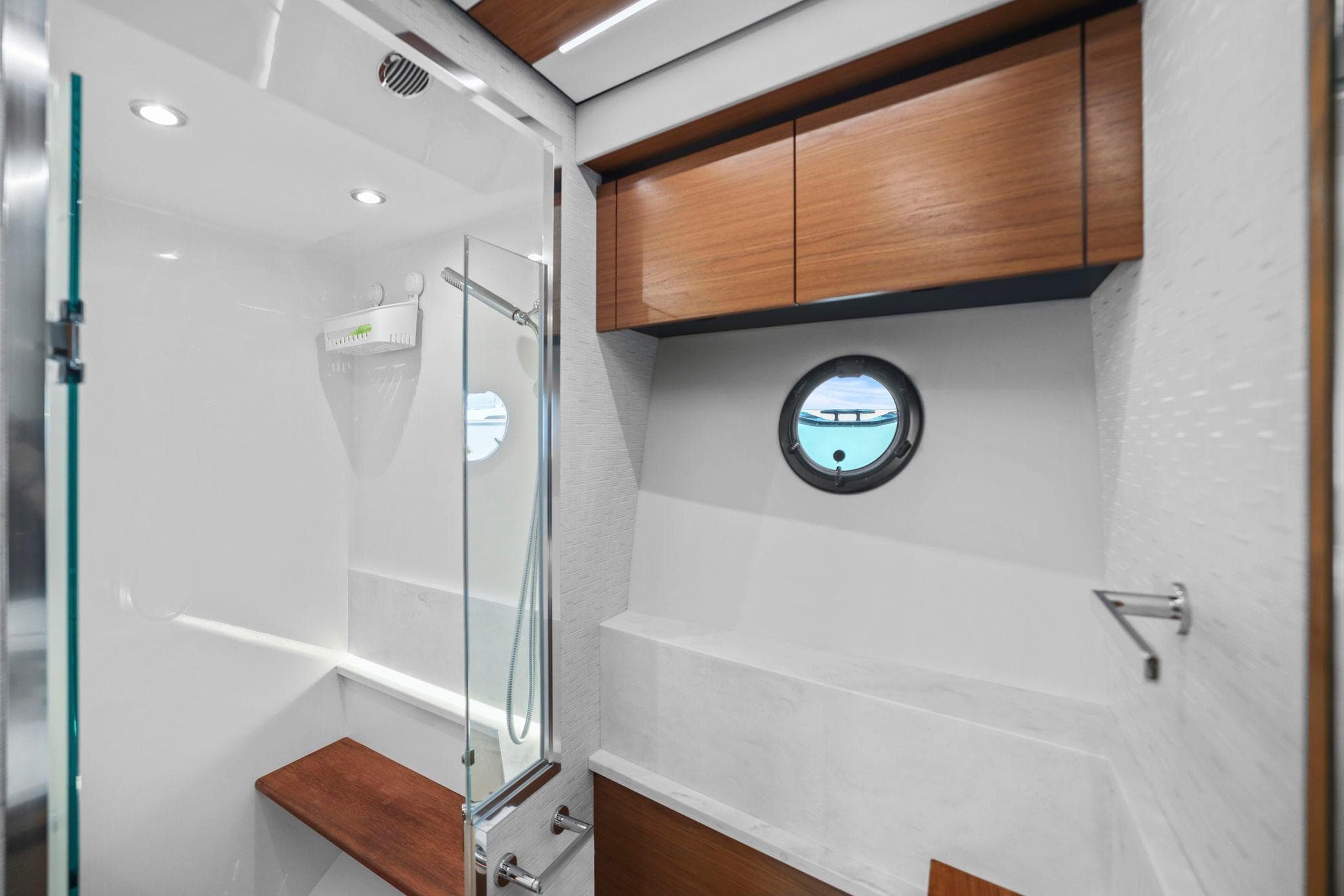 Luxurious bathroom in 2023 Tiara Yachts C49 Coupe with modern fixtures and wood accents.