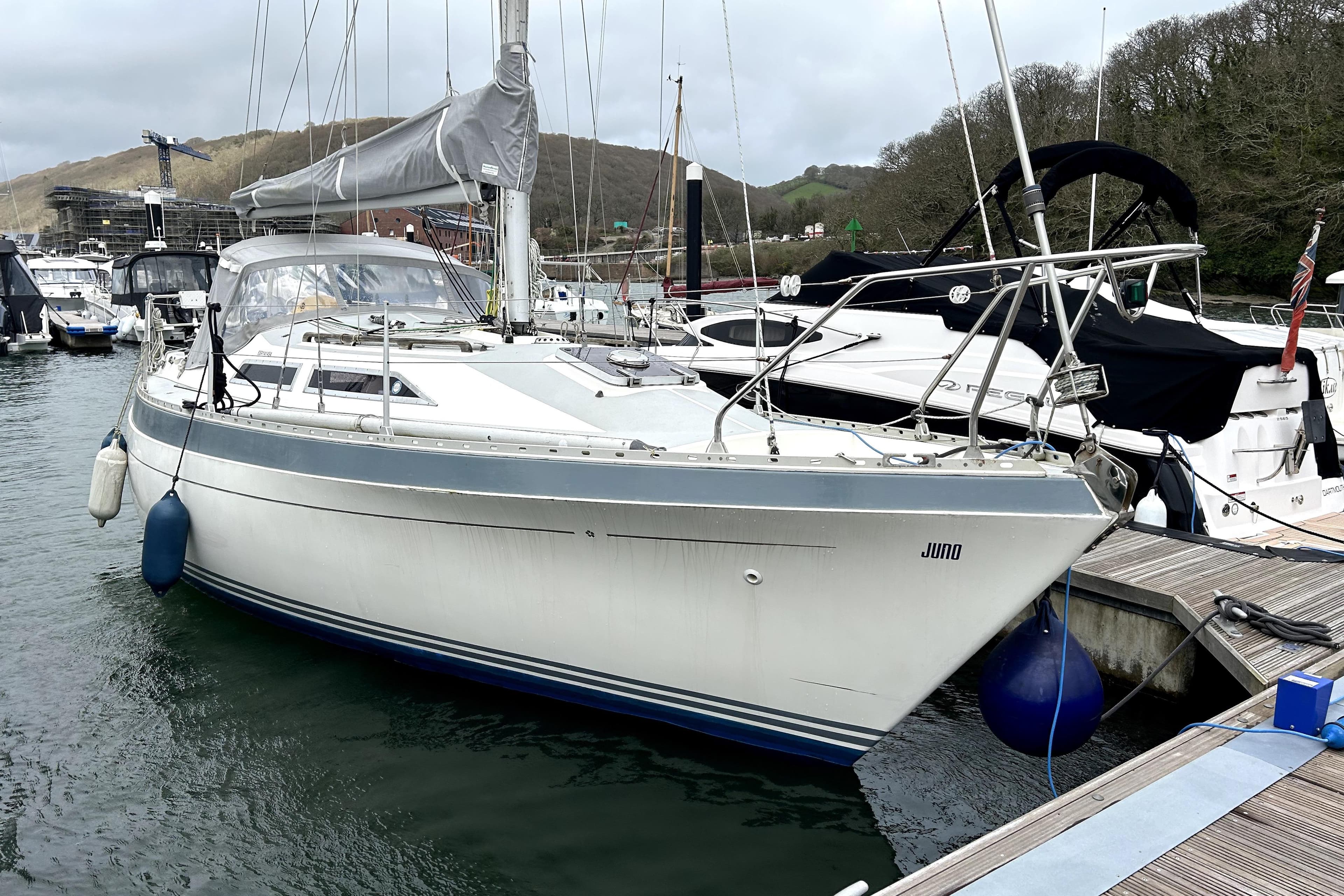 1983 Moody 29 sailboat docked in a marina, surrounded by other boats.