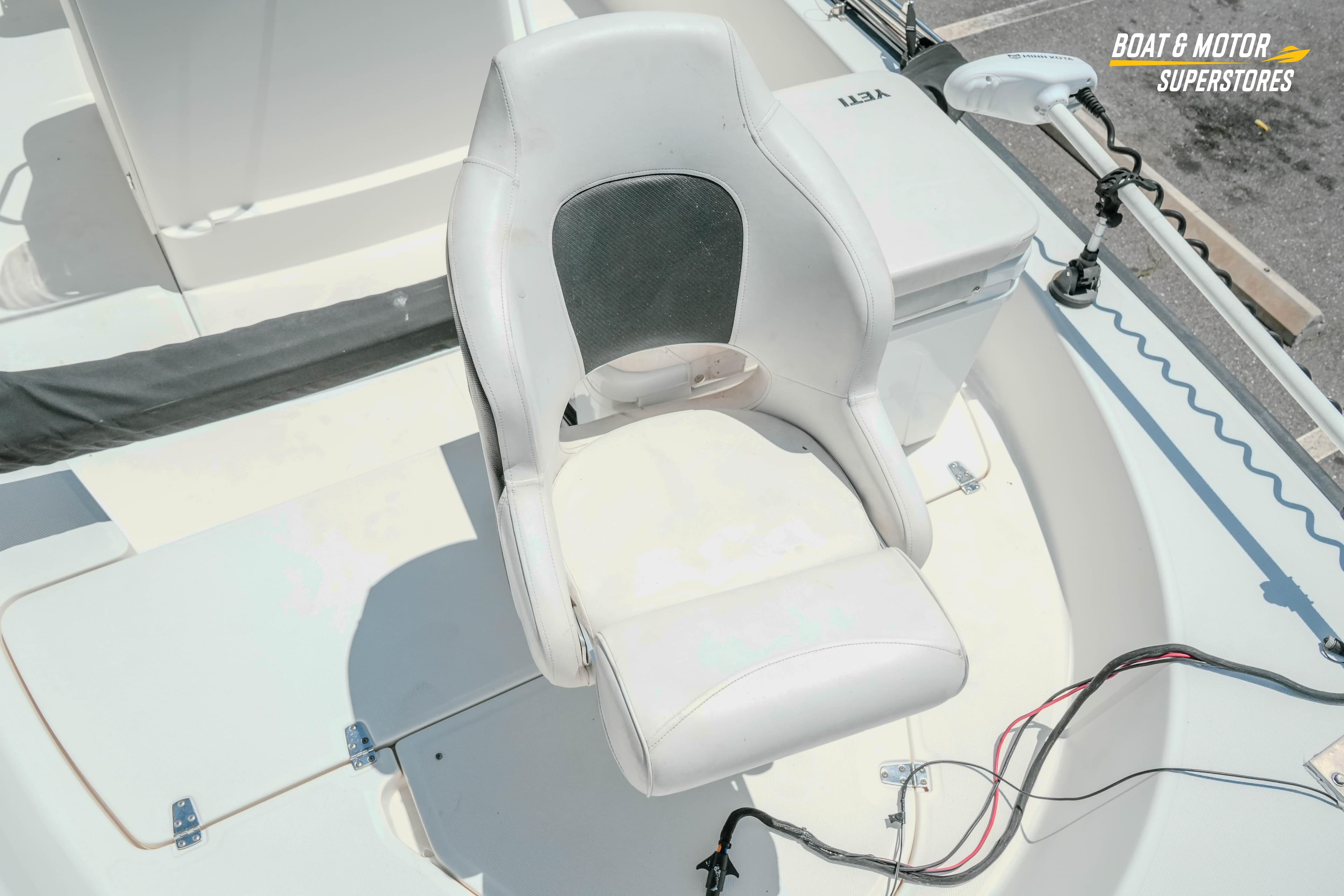 2016 Boston Whaler 210 Montauk boat seat with fishing equipment and storage.