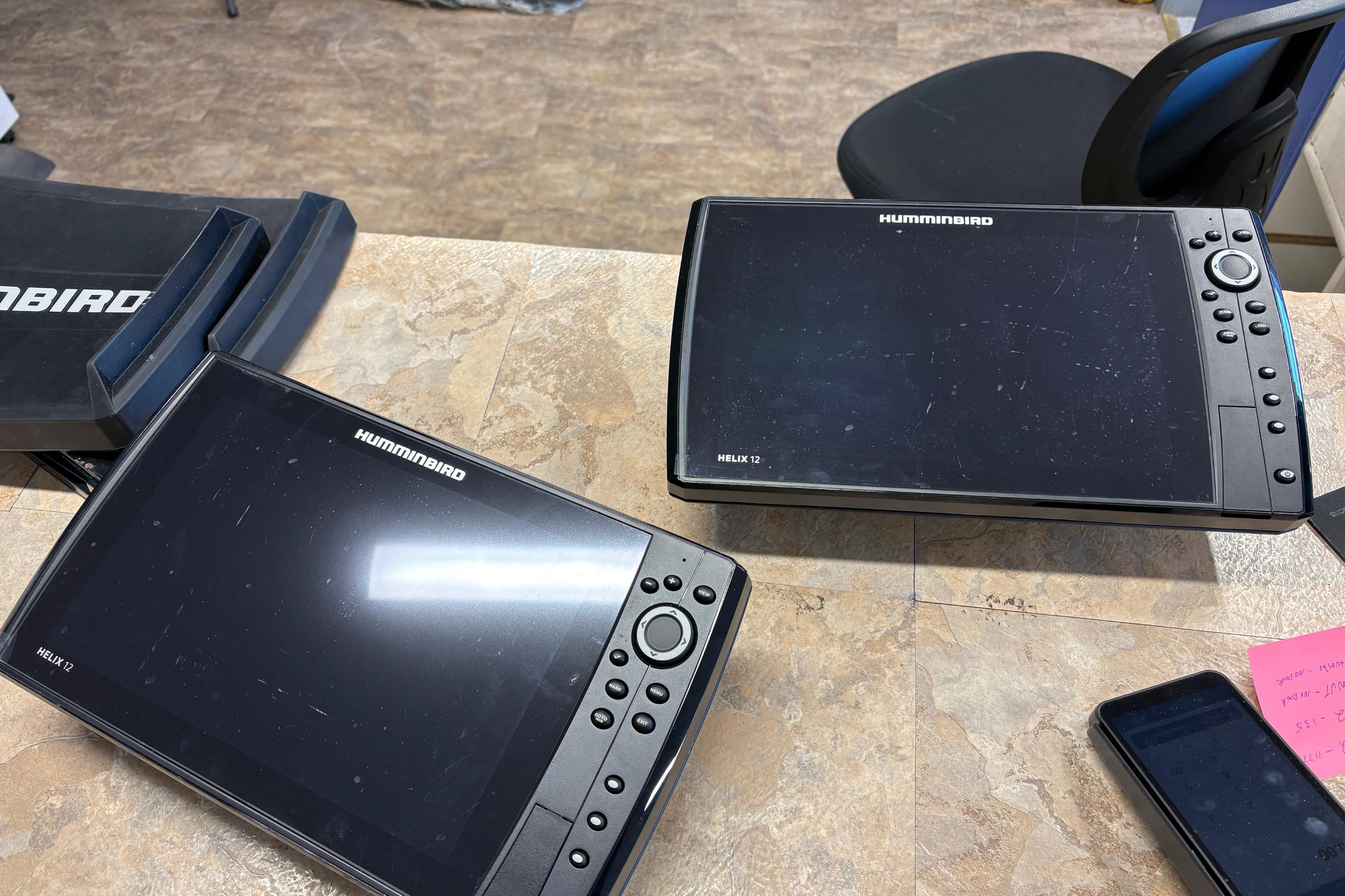 Humminbird Helix 12 fish finders on a table, related to 2022 Lund 1875 Pro-V Bass XS.
