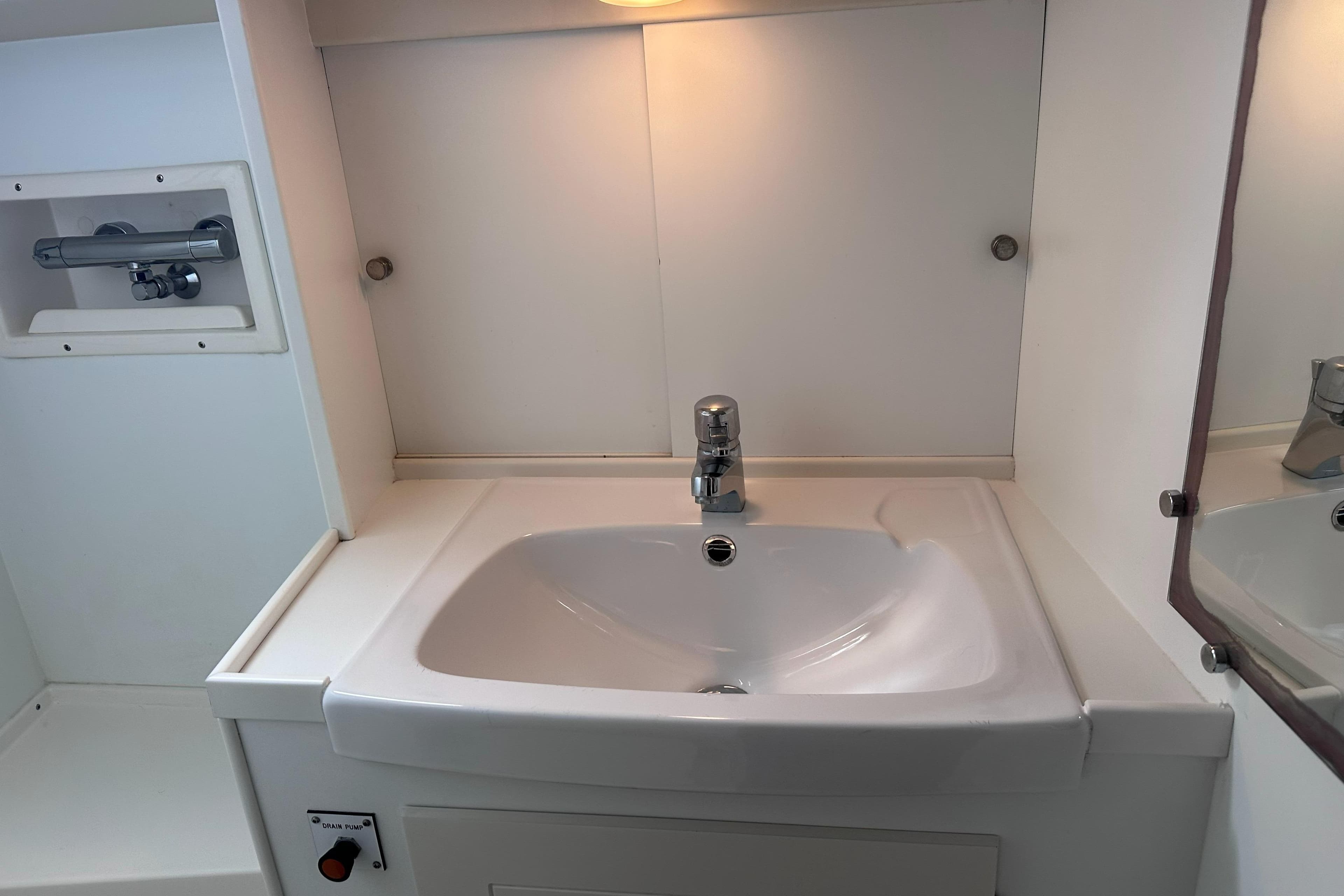 Bathroom sink area in a 2000 Hallberg-Rassy 46 yacht, featuring modern fixtures.