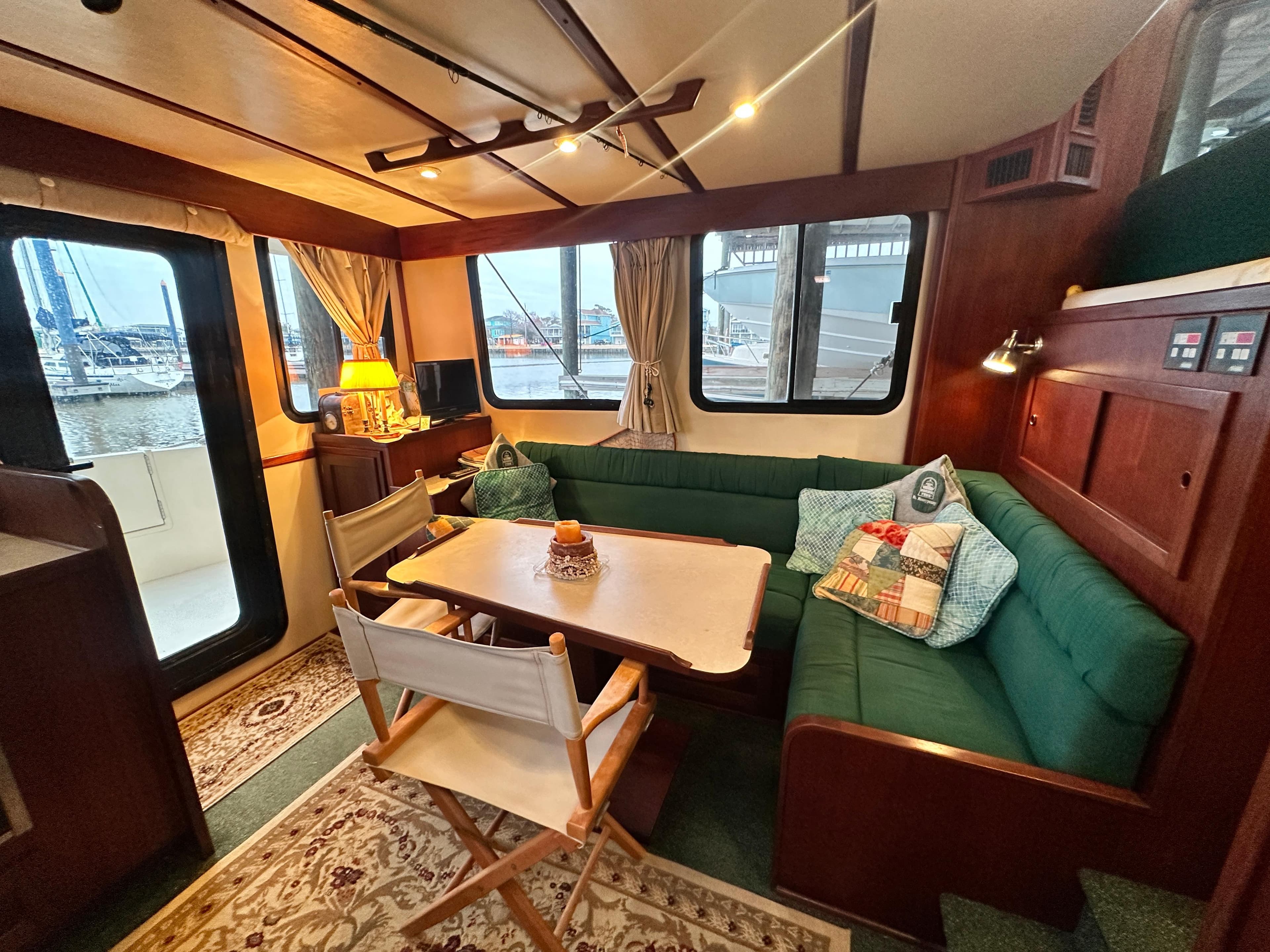 Interior of 2001 Nordic Tug 37, featuring cozy seating and nautical decor.