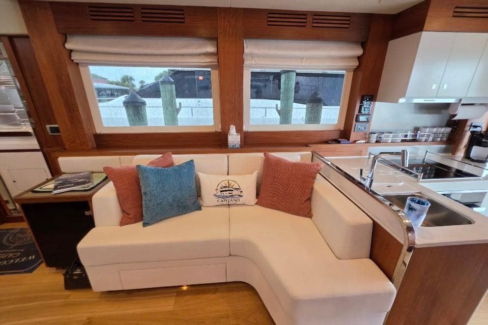 Luxurious interior of 2024 Sirena 58 Flybridge MY yacht with cozy seating and modern kitchen.