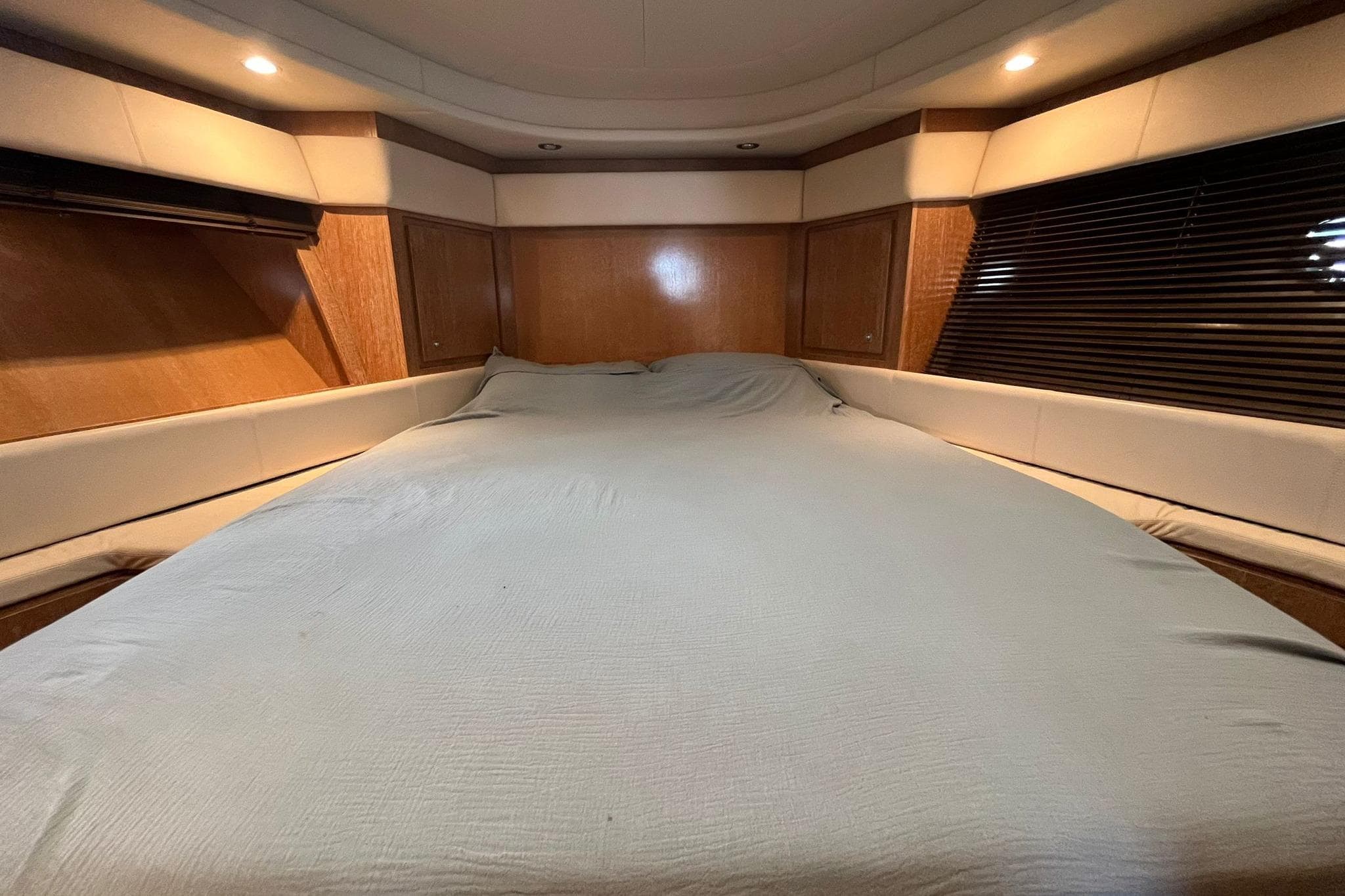 Luxurious cabin interior of 2007 Rizzardi Incredible 45 yacht with cozy bed.