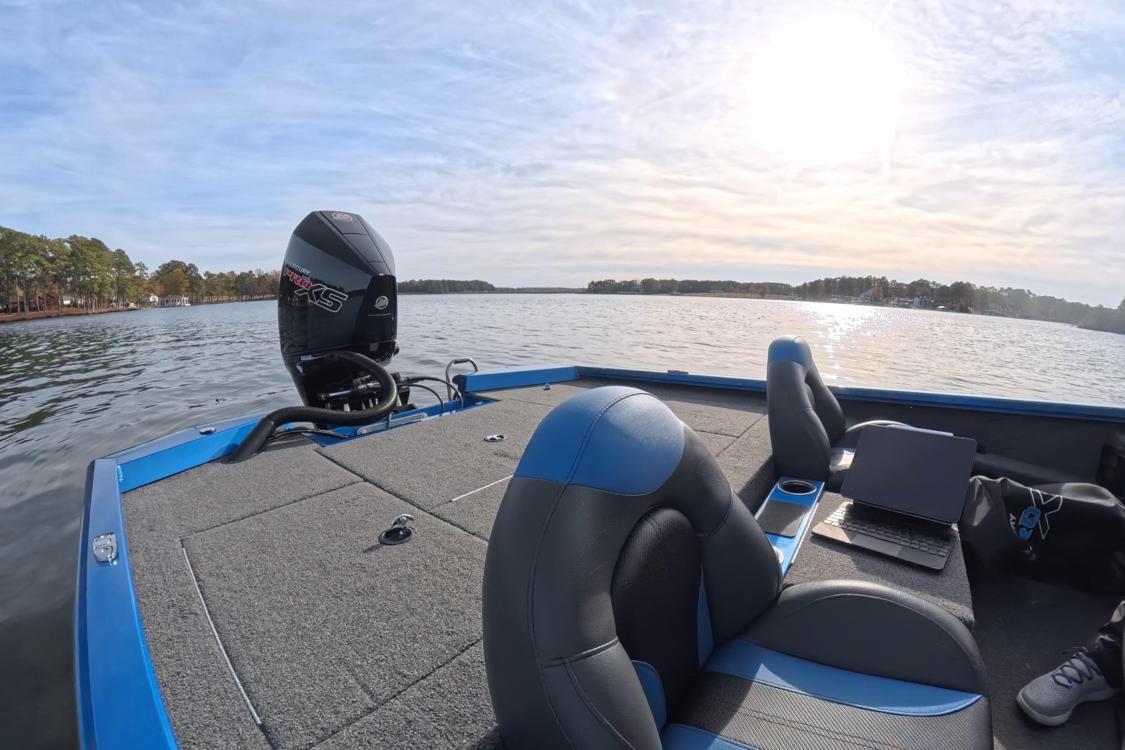 2022 Vexus AVX 2080 boat on a lake, featuring a Mercury engine and comfortable seating.