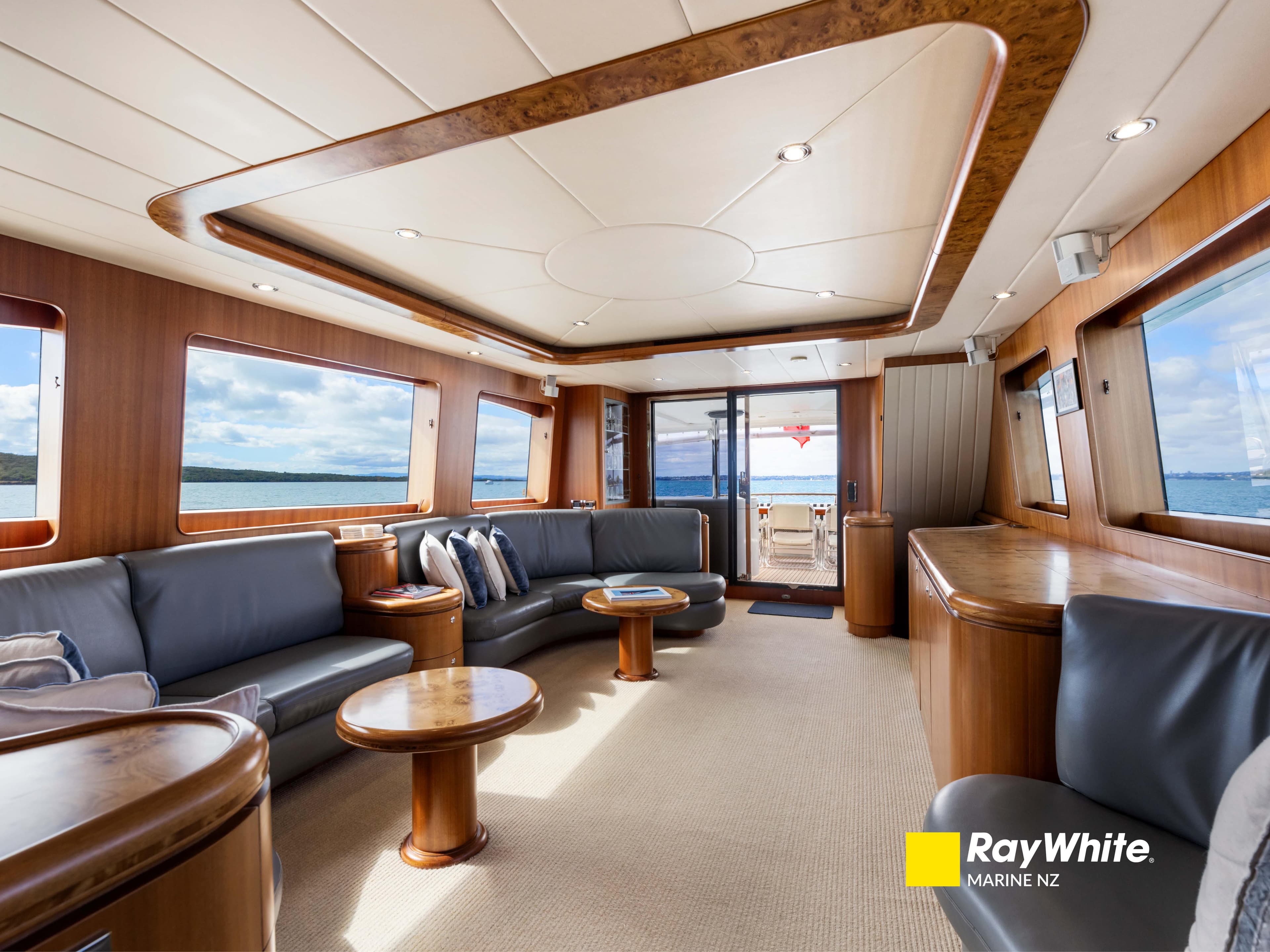 Luxurious interior of 2006 Horizon E76 yacht with elegant wood finishes and ocean views.