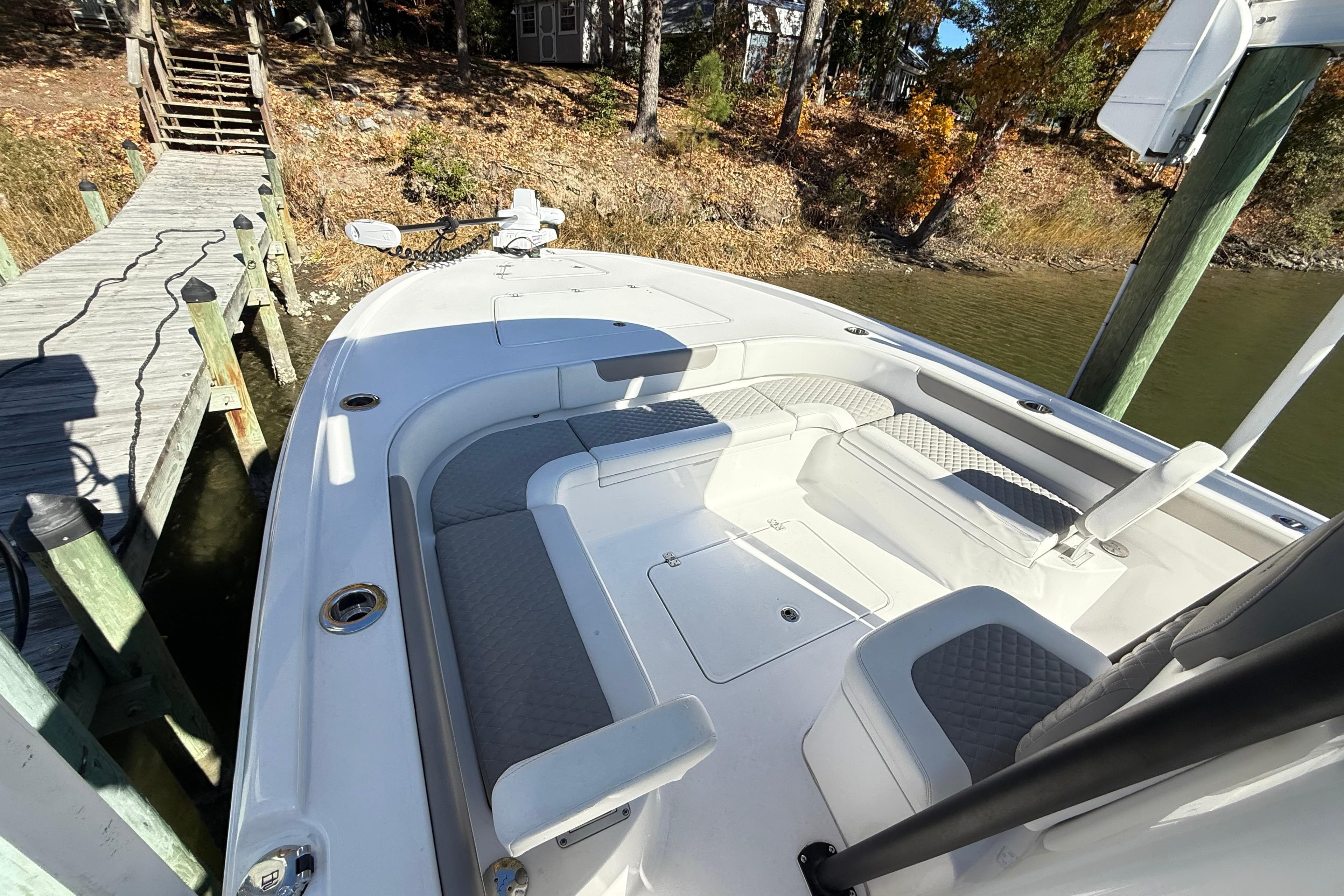 2023 Caymas 281 HB boat docked, featuring spacious seating and modern design.