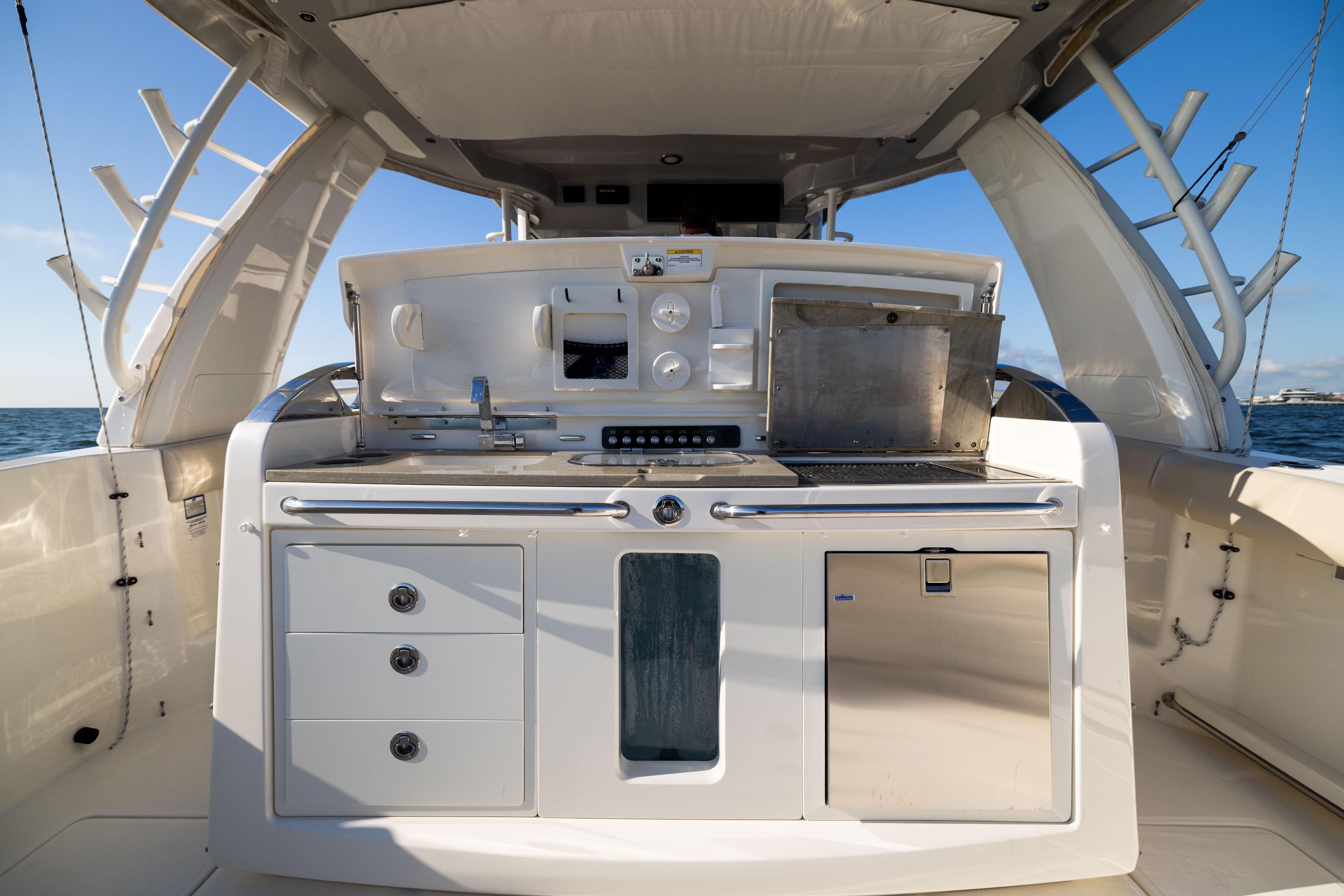 2021 Boston Whaler 420 Outrage boat kitchen area with grill and storage.