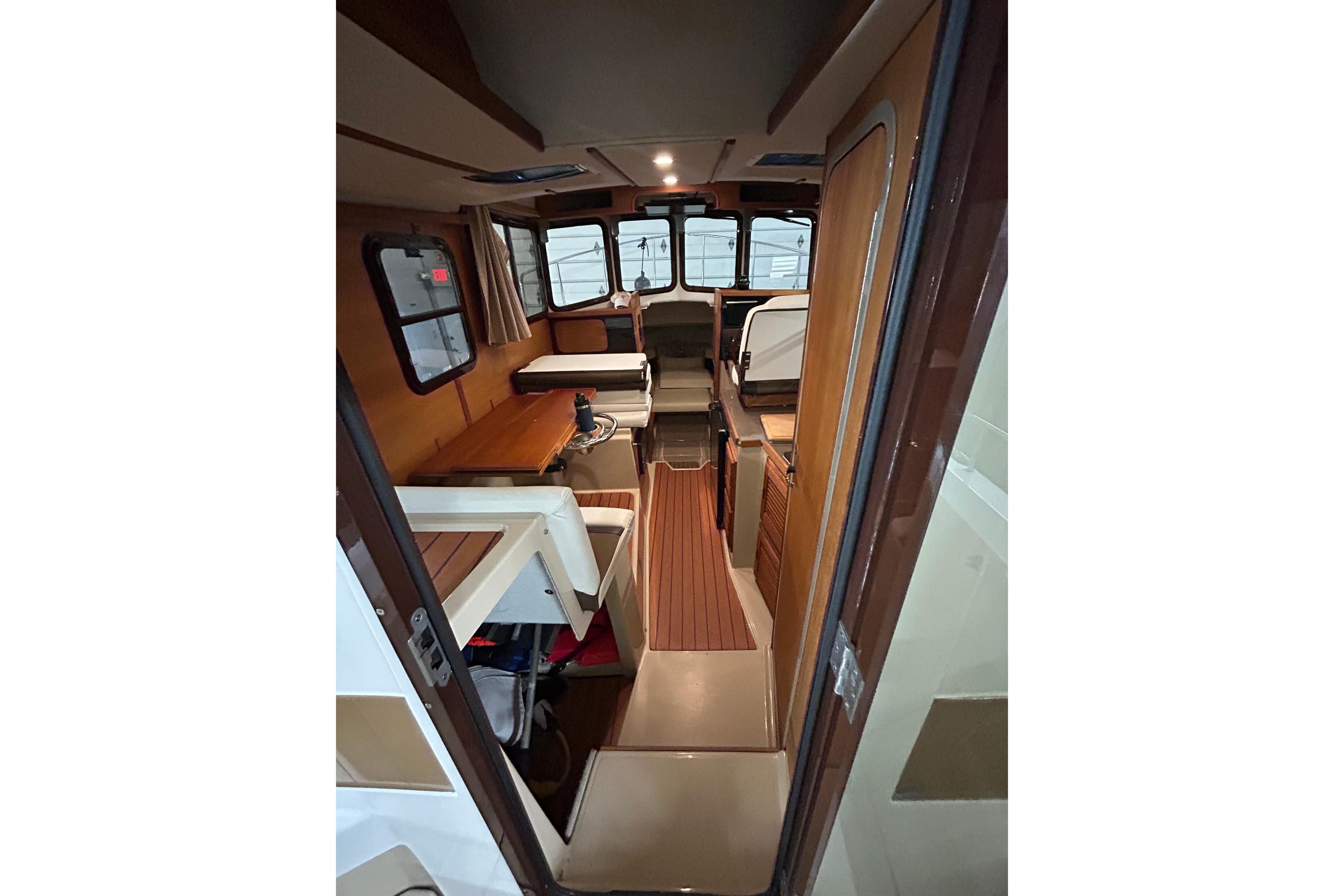 Interior of 2017 Ranger Tugs R-25 SC, featuring wood accents and seating area.