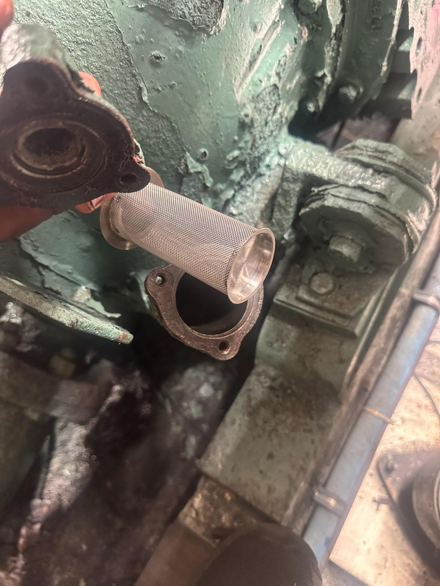 Engine component of a 1982 Bertram 46.6 War Wagon with a metal filter.
