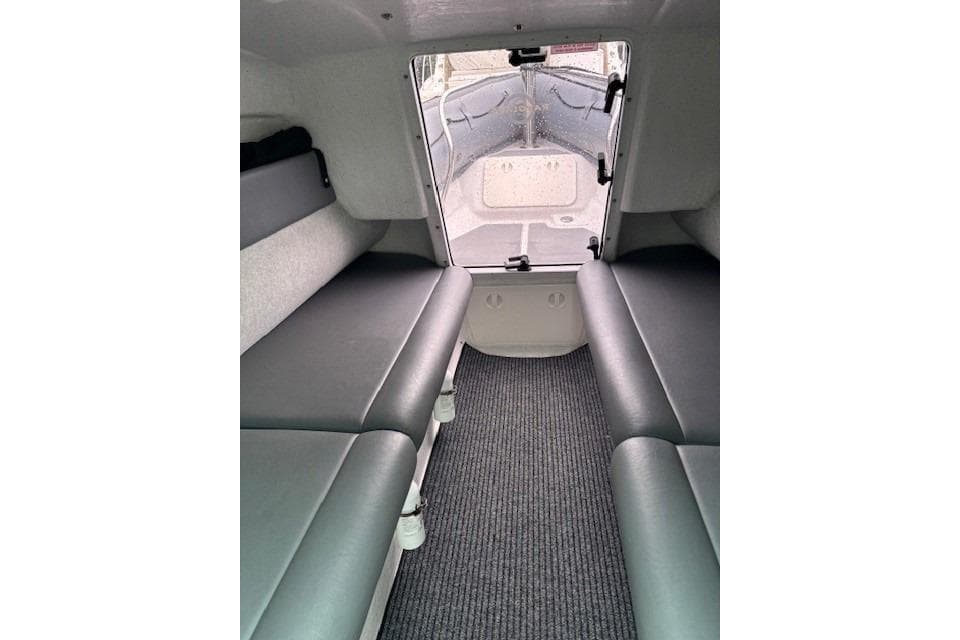 Interior cabin of 2008 Protector Targa 28 boat with gray seating and carpet.