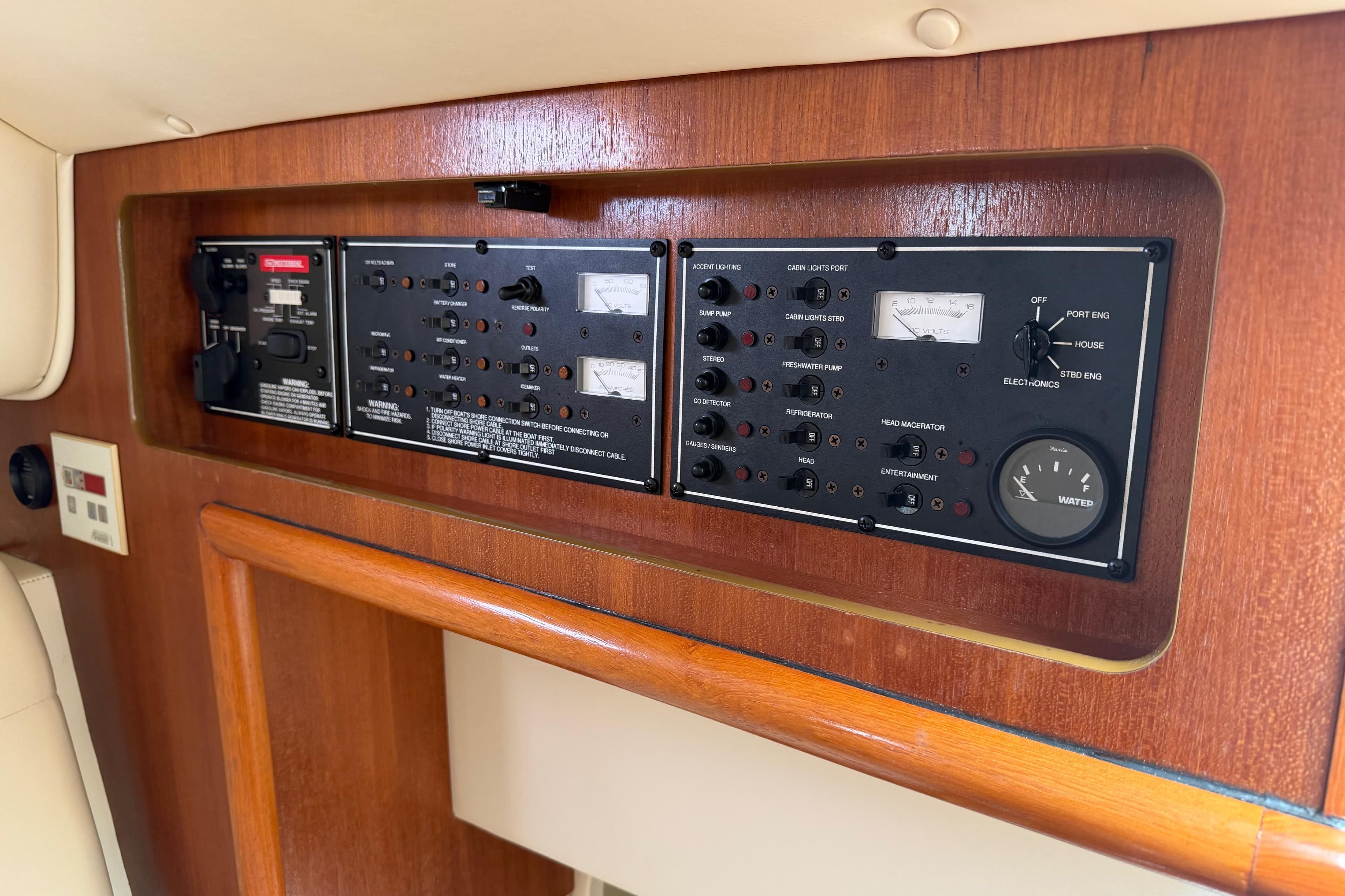 Control panel of a 2008 Pursuit OS 335 Offshore boat, featuring various switches and gauges.