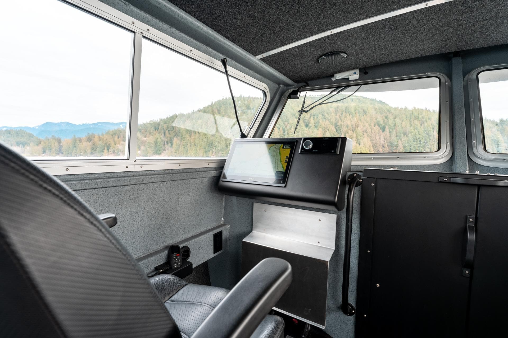 Interior of 2023 Liquid Metal Marine Maquinna Crew boat with control panel and scenic view.
