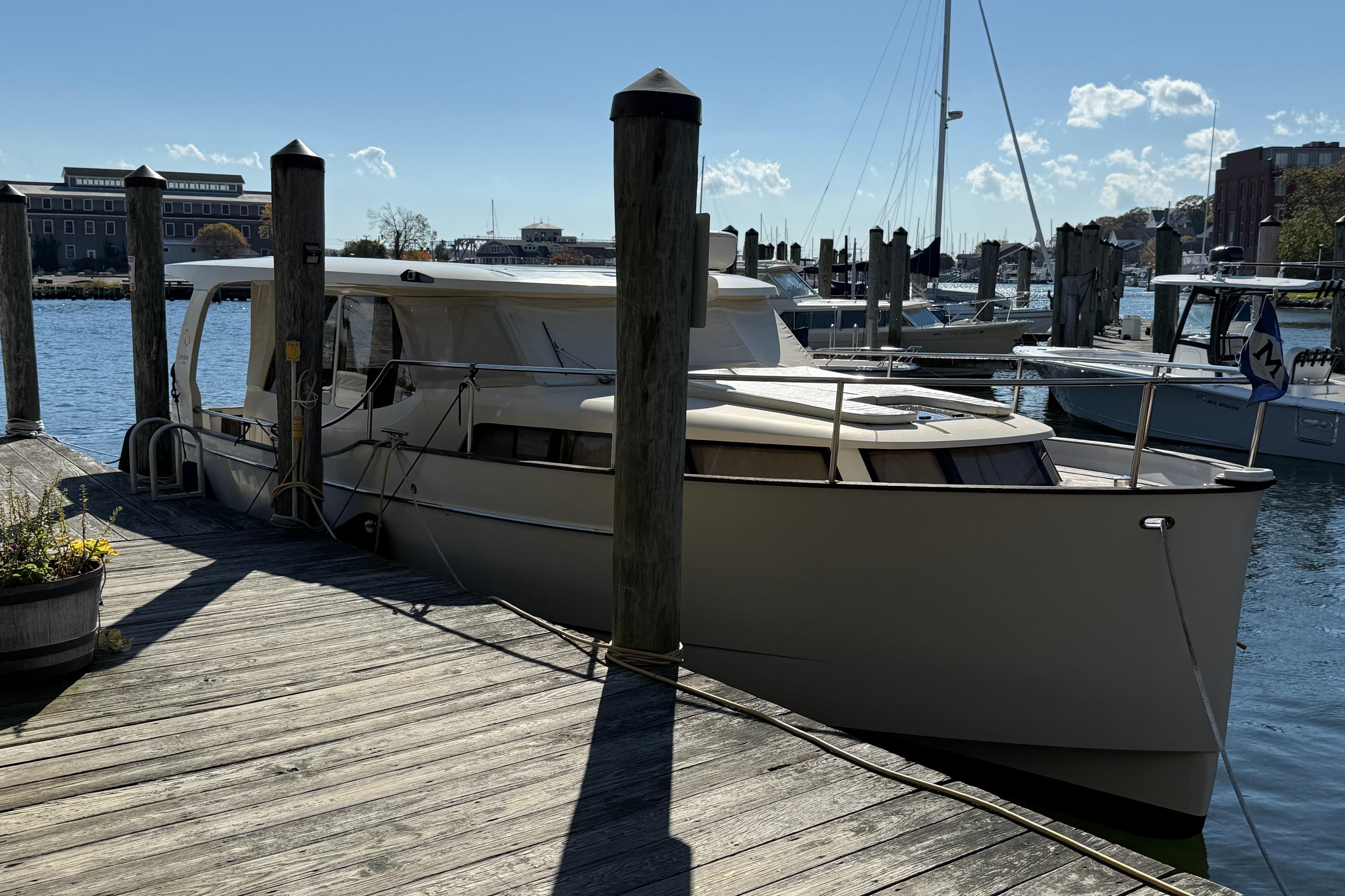 2013 Greenline 33 yacht docked at a marina on a sunny day.