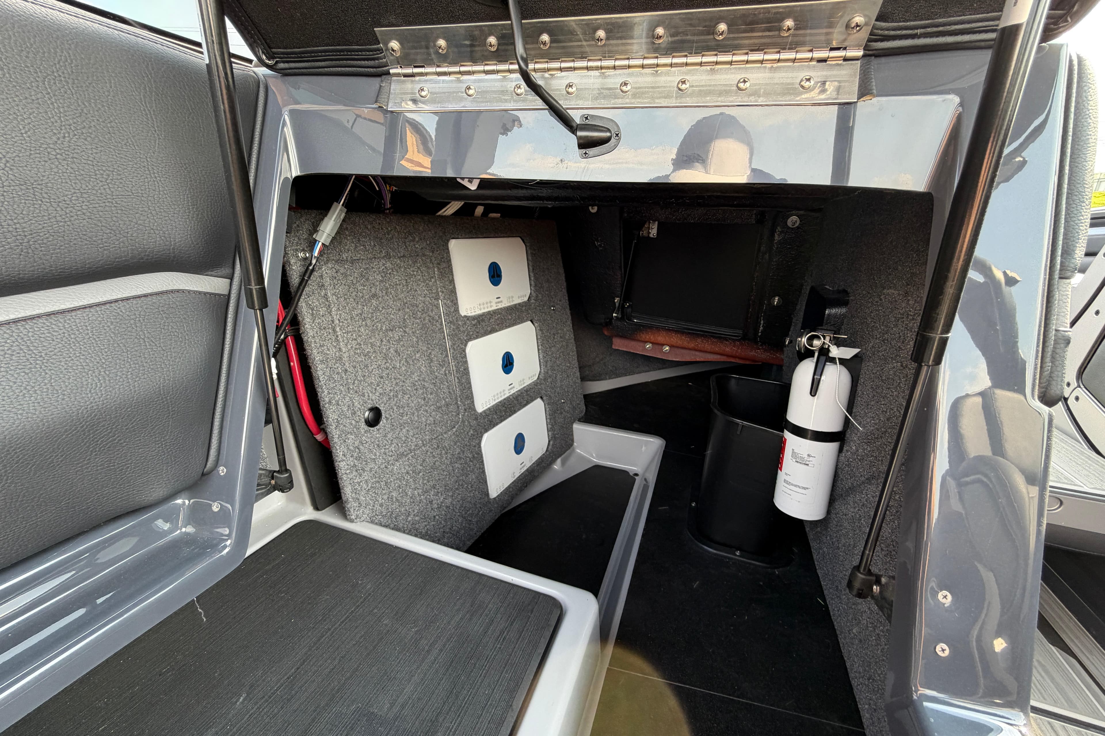 2023 Supra SL 550 interior storage compartment with fire extinguisher and equipment.