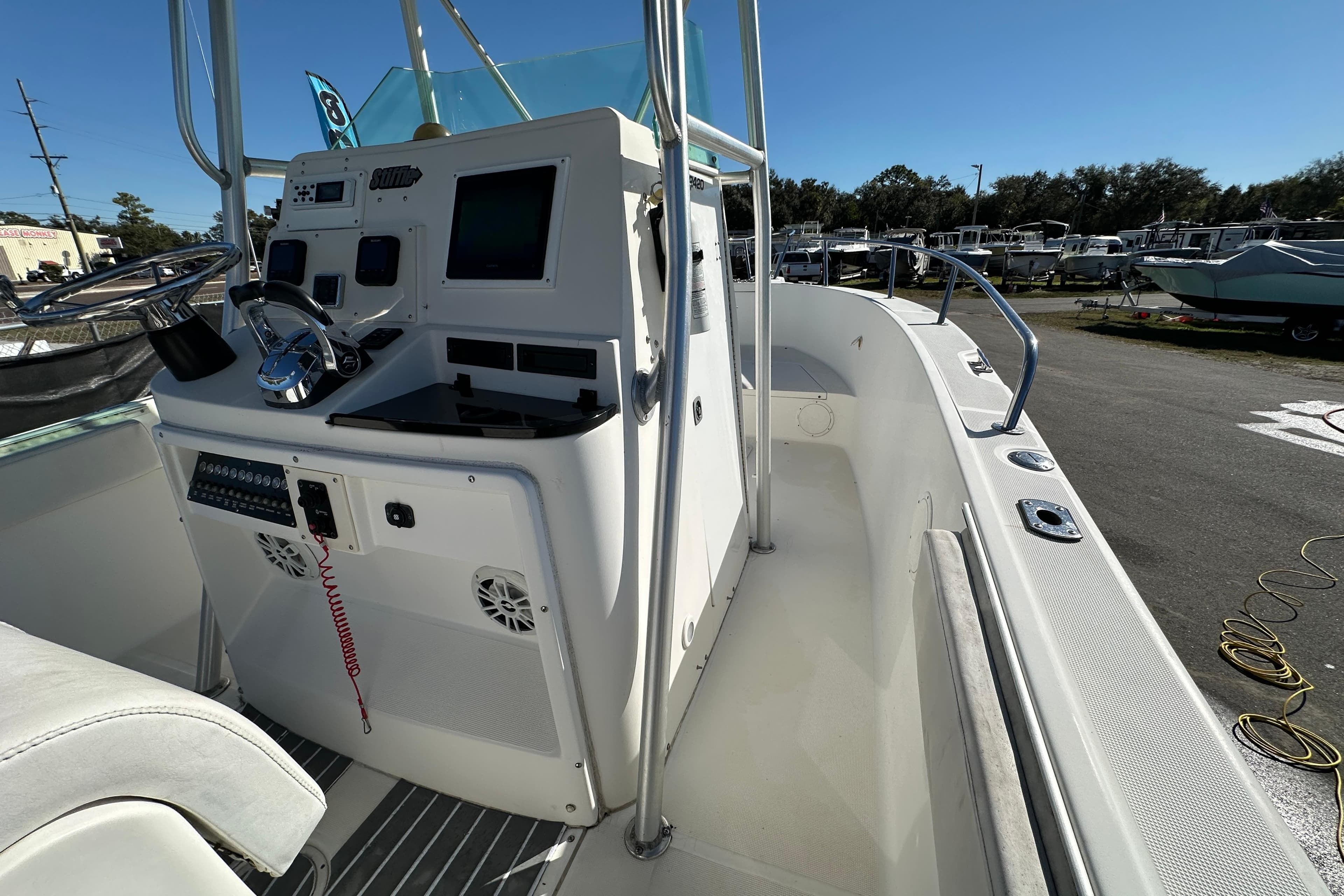 1999 Robalo 2420 Center Console boat interior with steering wheel and control panel.