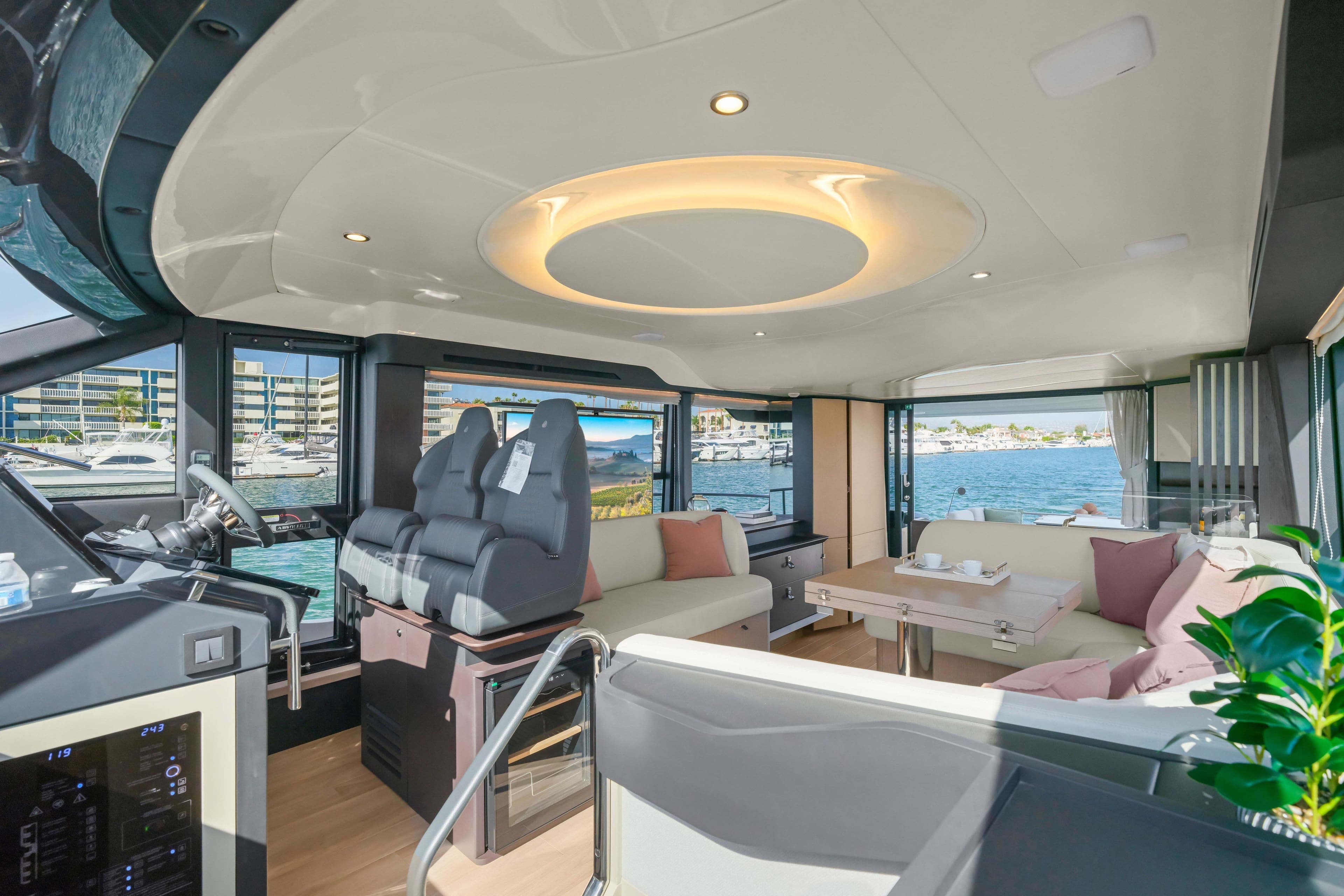 Luxurious interior of 2026 Absolute 52 Fly yacht with modern seating and scenic views.