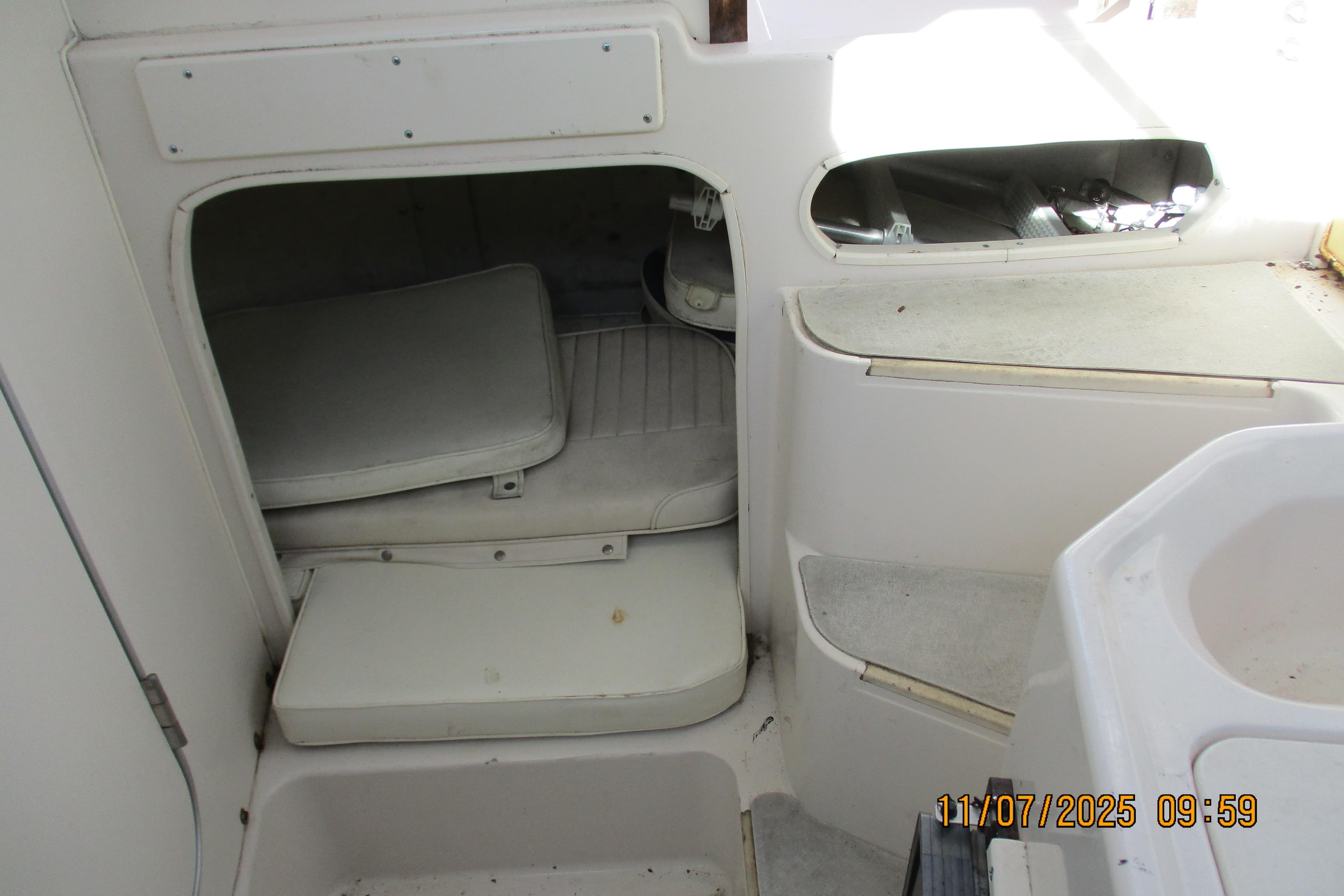 Interior cabin of 1996 Grady-White Sailfish 272 boat, showing seating and storage.