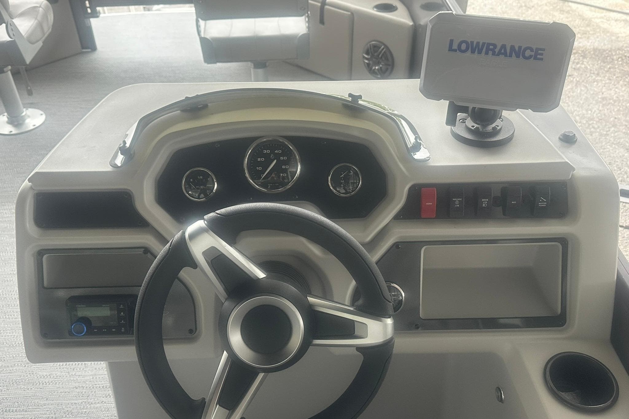 Steering console of 2026 Sweetwater 2286FX boat with Lowrance navigation system.