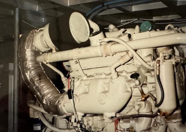Engine of 1990 Motor Yacht 70 Brata, showcasing intricate mechanical components.