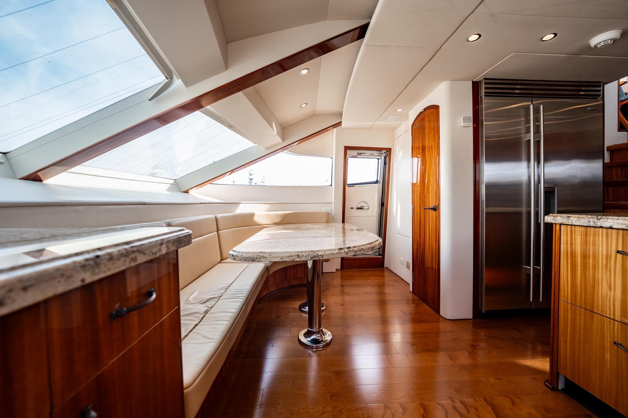 Luxurious interior of 2012 Hatteras 80 Motor Yacht with elegant wood finishes and modern design.