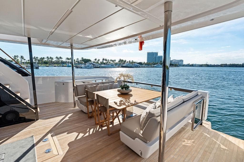 Luxurious 2023 Ferretti Yachts 860 deck with elegant seating and scenic waterfront view.