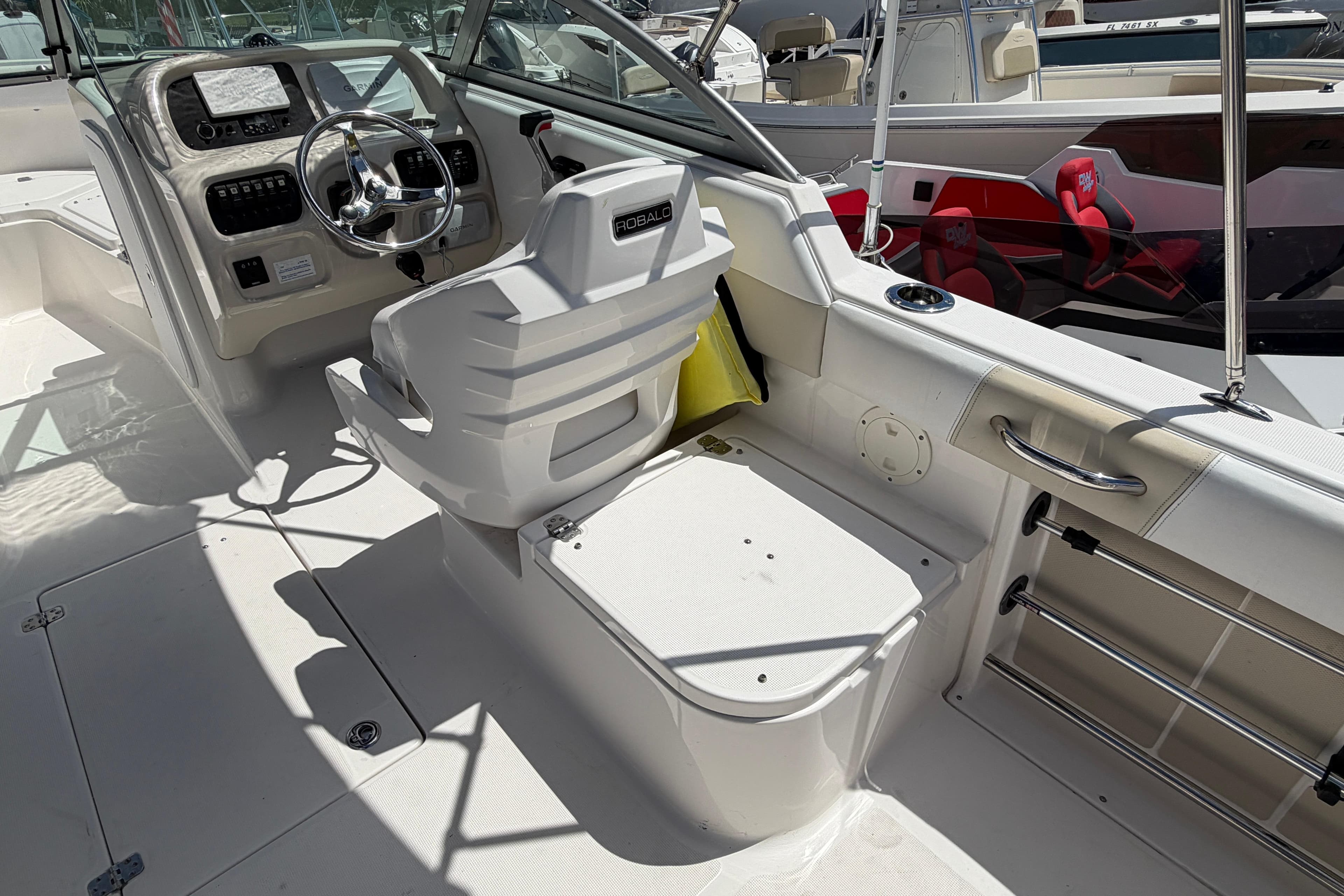 2015 Robalo R227 Dual Console boat interior with steering wheel and seating area.