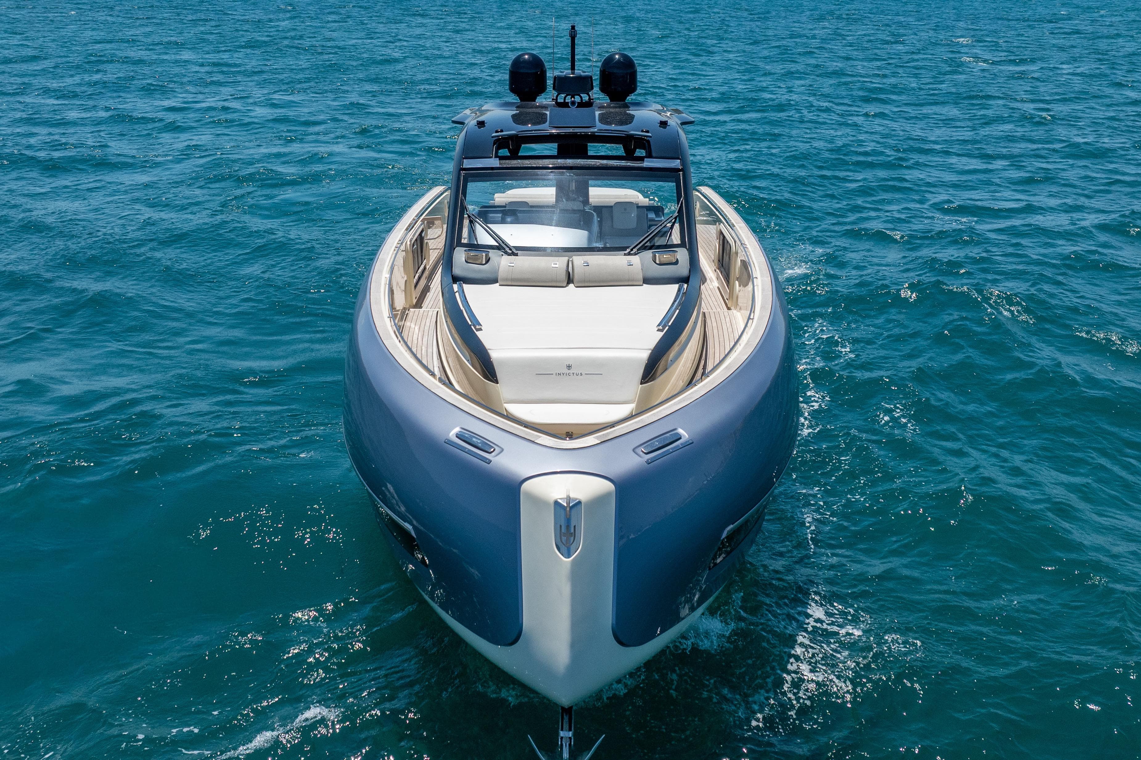2024 Invictus TT460 yacht cruising on open blue sea.