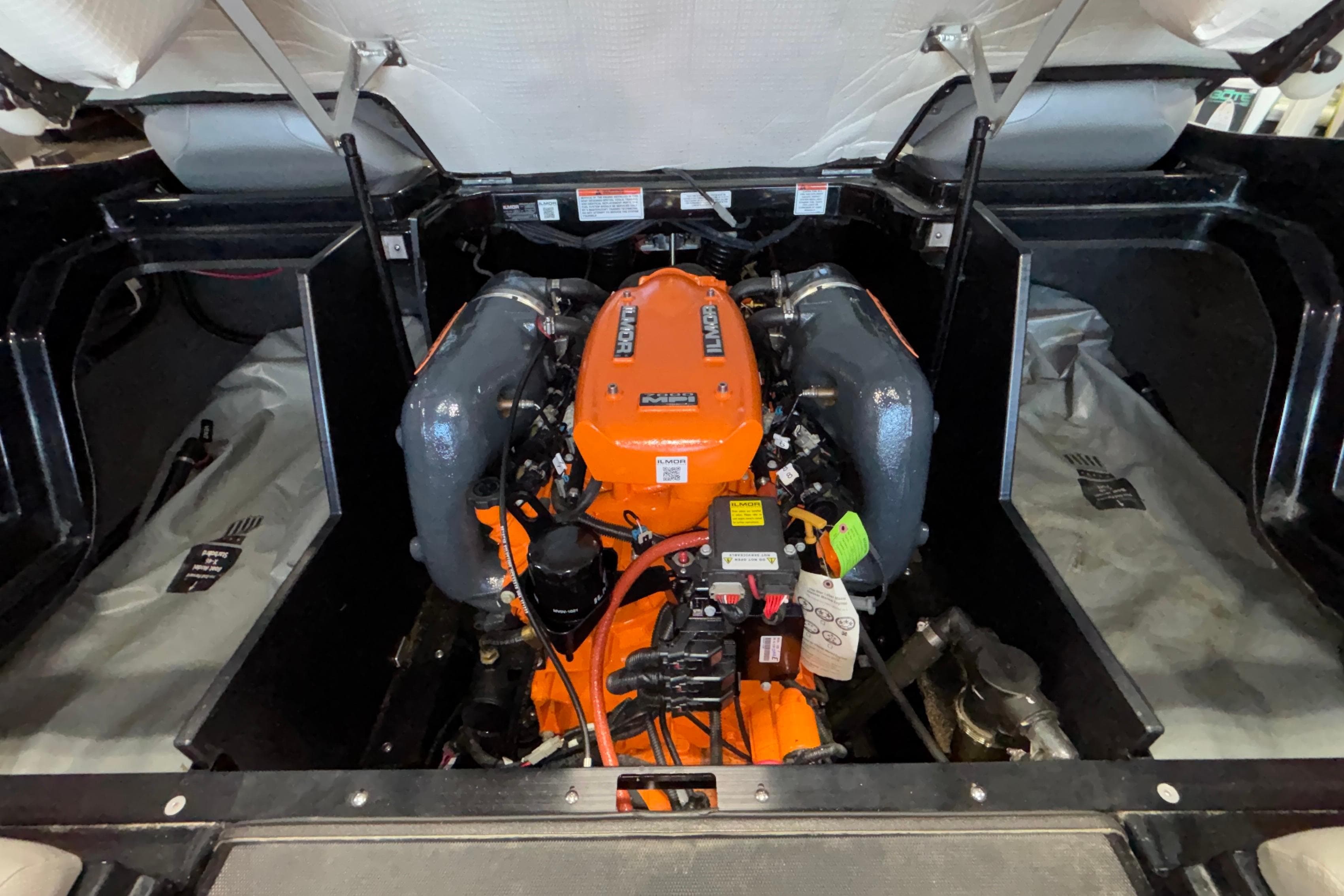 2017 MasterCraft X46 engine compartment with vibrant orange engine components.