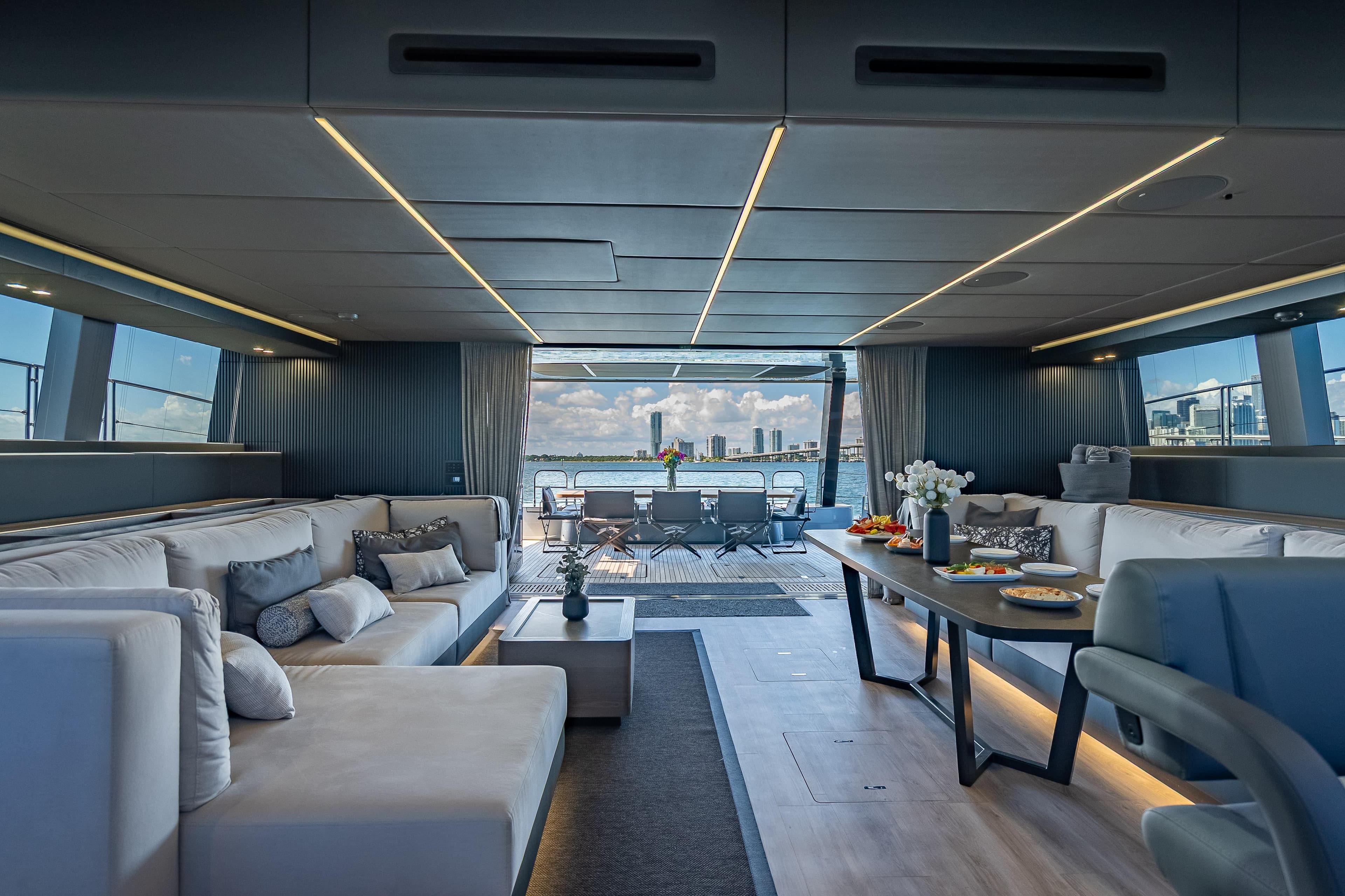 Luxurious interior of 2026 Sunreef 60 Power yacht with elegant seating and dining area.