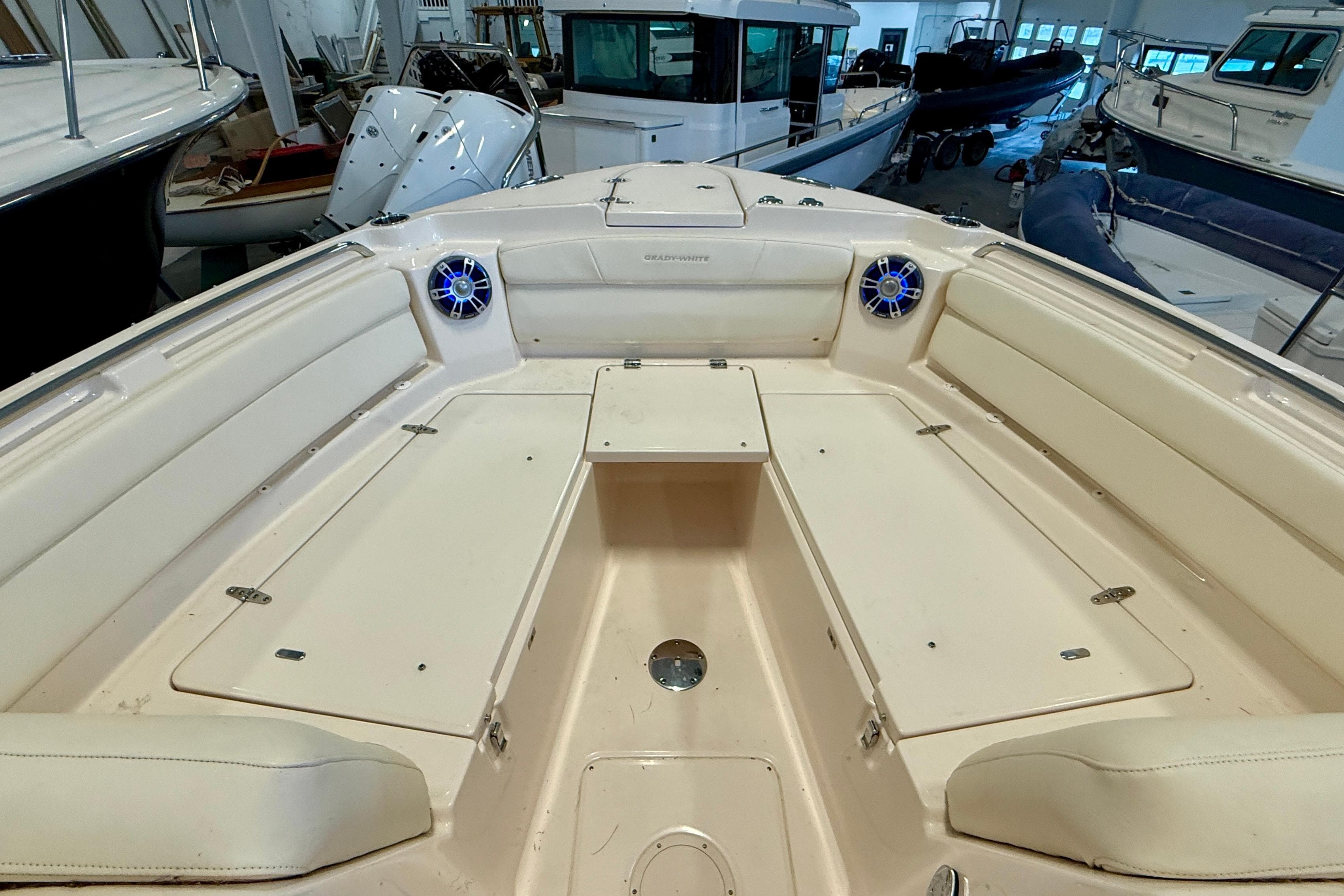 2023 Grady-White Freedom 285 boat interior with seating and speakers in a showroom.